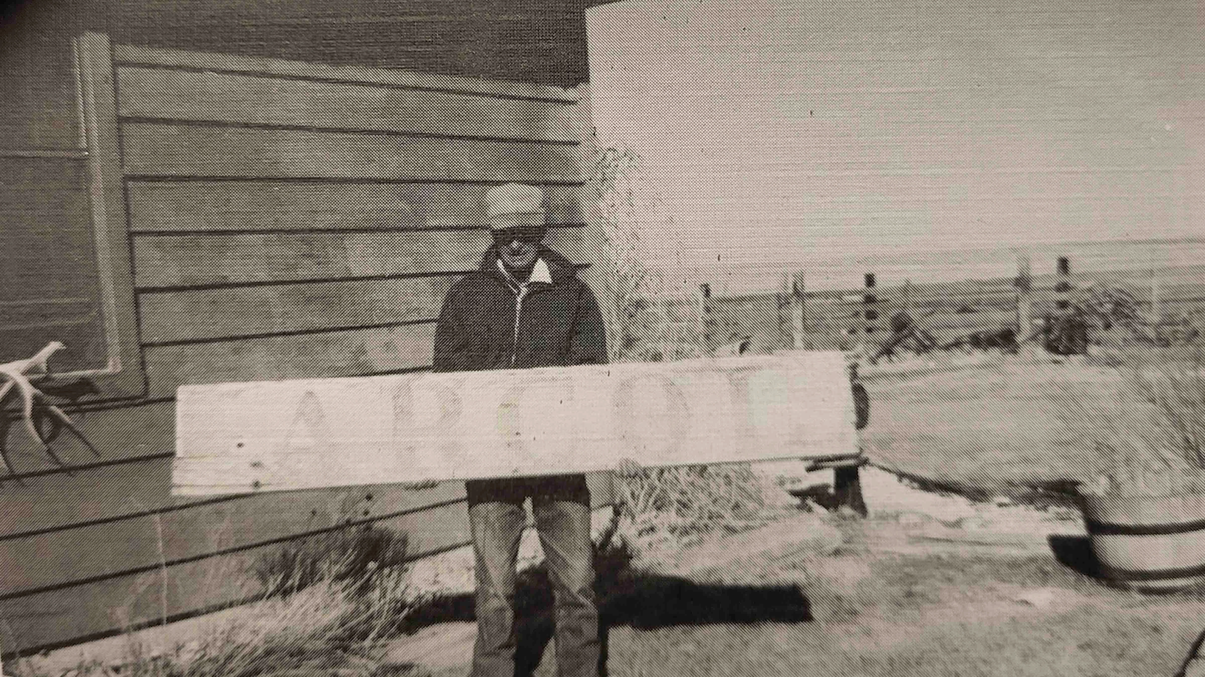 A 1997 photo of the Arcola Depot sign, held by an unknown individual