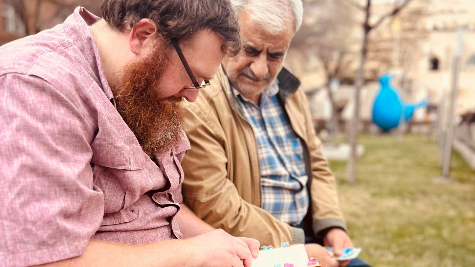 One of Vision Beyond Borders team members sharing a Farsi Bible with a man from Iran on the streets of Armenia.