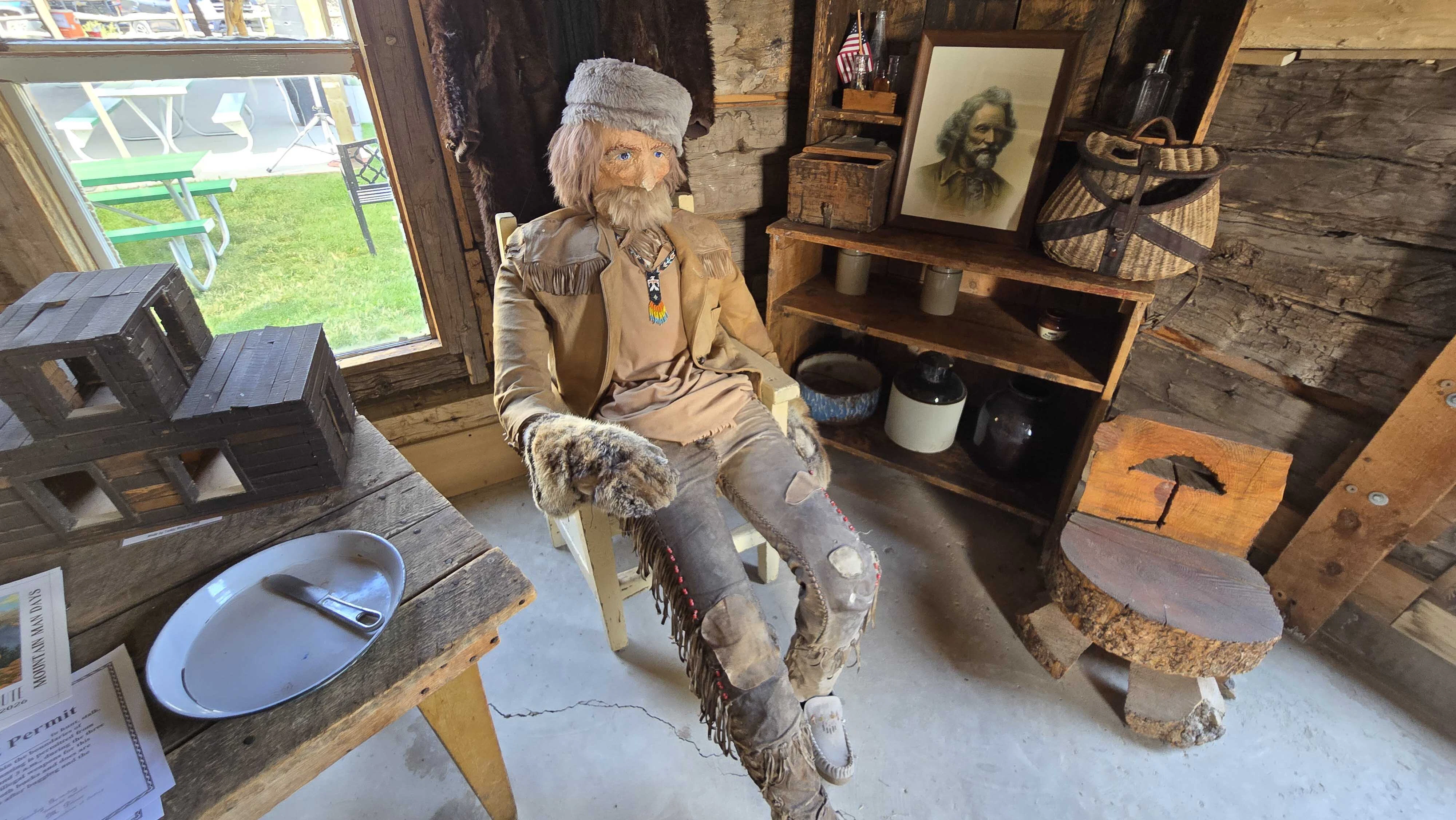 A mannequin evoking Jim Baker of old inside his cabin, which is preserved at Little Snake River Museum in Savery.