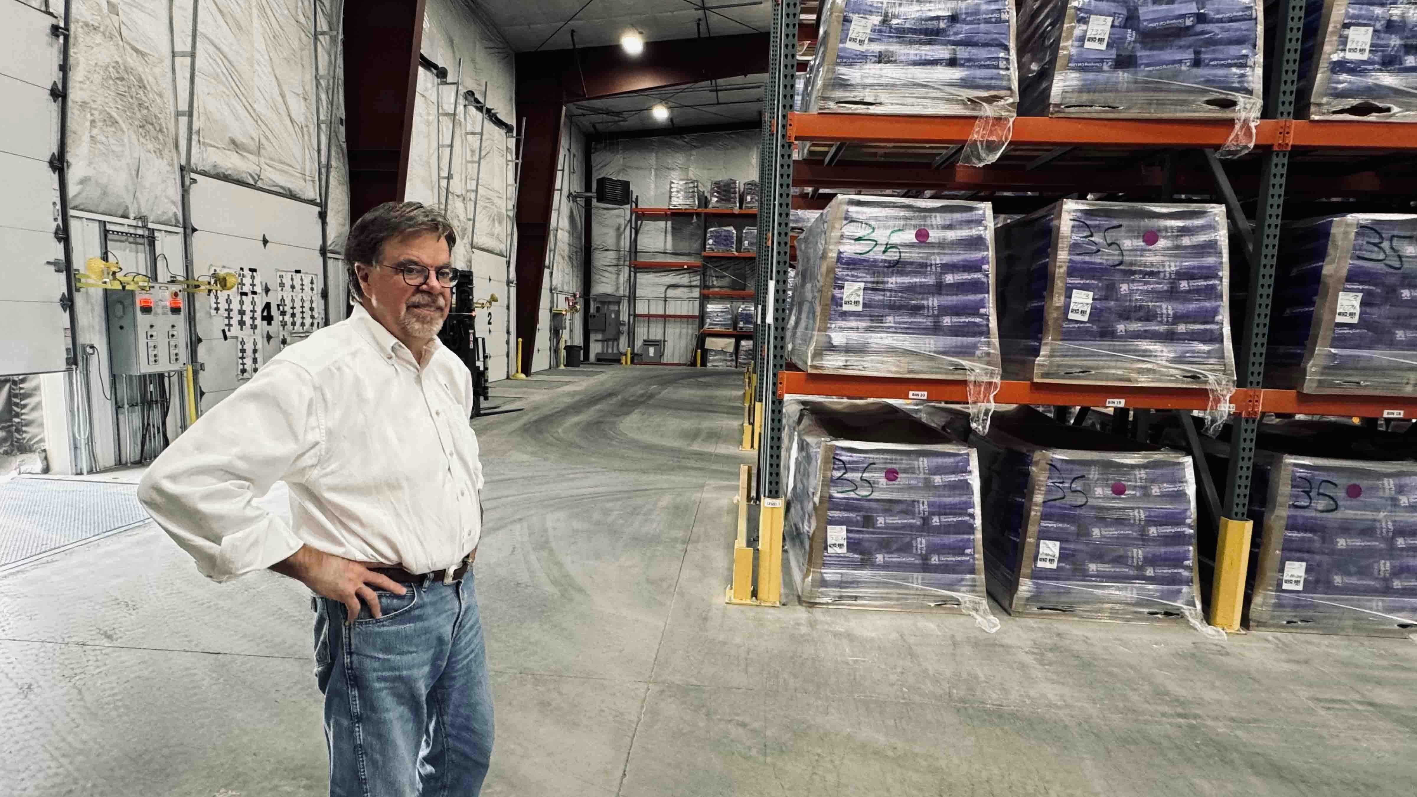 Wyo-Ben Inc. CEO David Brown standing inside the warehouse of a newly constructed cat litter processing plant in Billings, Montana, where some of the company’s bentonite ends up getting packaged into bags of cat litter for big retailers like Target’s Up&Up brand. The pallets are filled to the rafters in the warehouse with the cat litter.