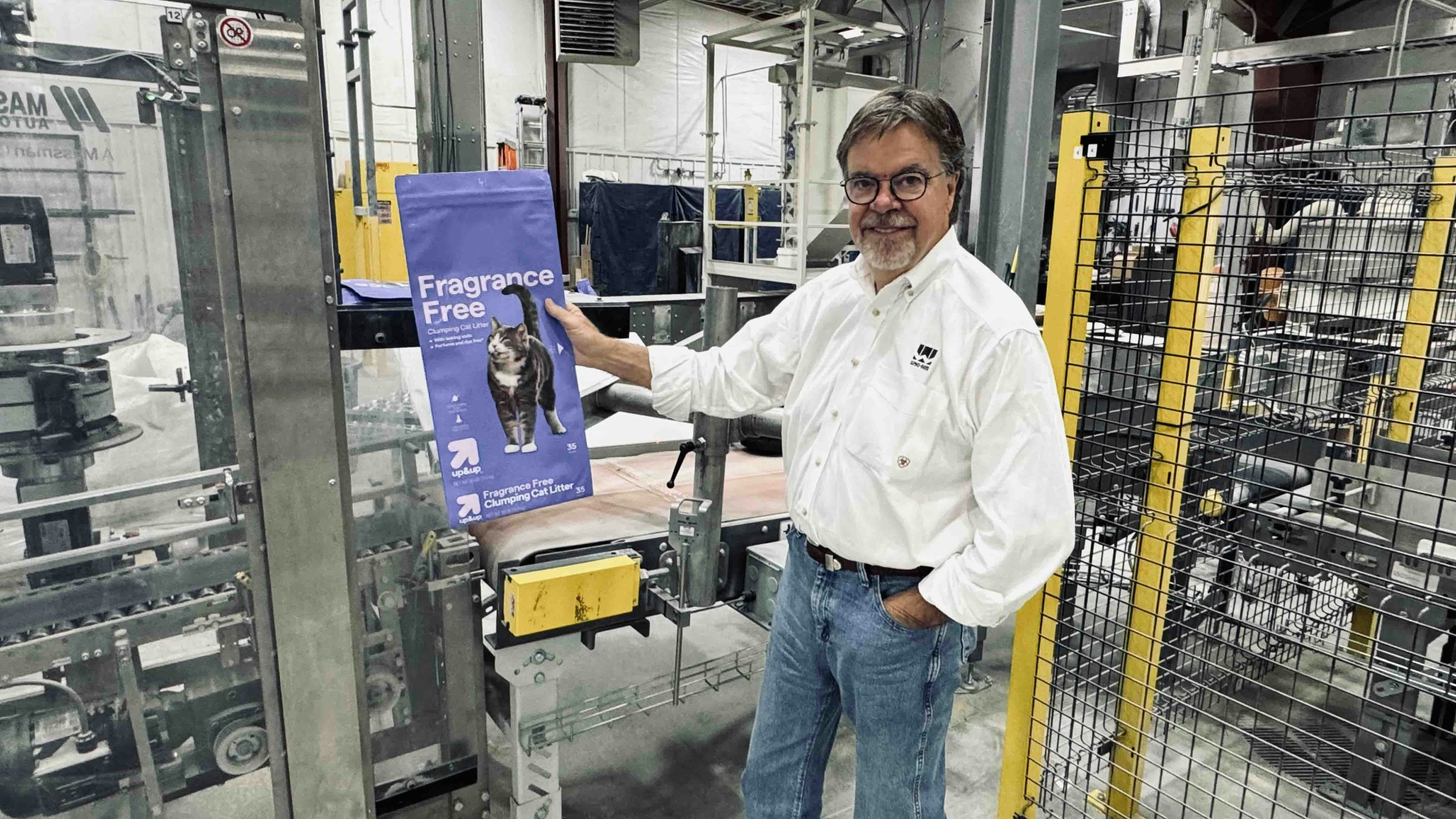 Wyo-Ben Inc. CEO David Brown standing inside the warehouse of a newly constructed cat litter processing plant in Billings, Montana, where he shows off a bag of Target branded cat litter produced from the company’s bentonite shipped from mines in Wyoming.