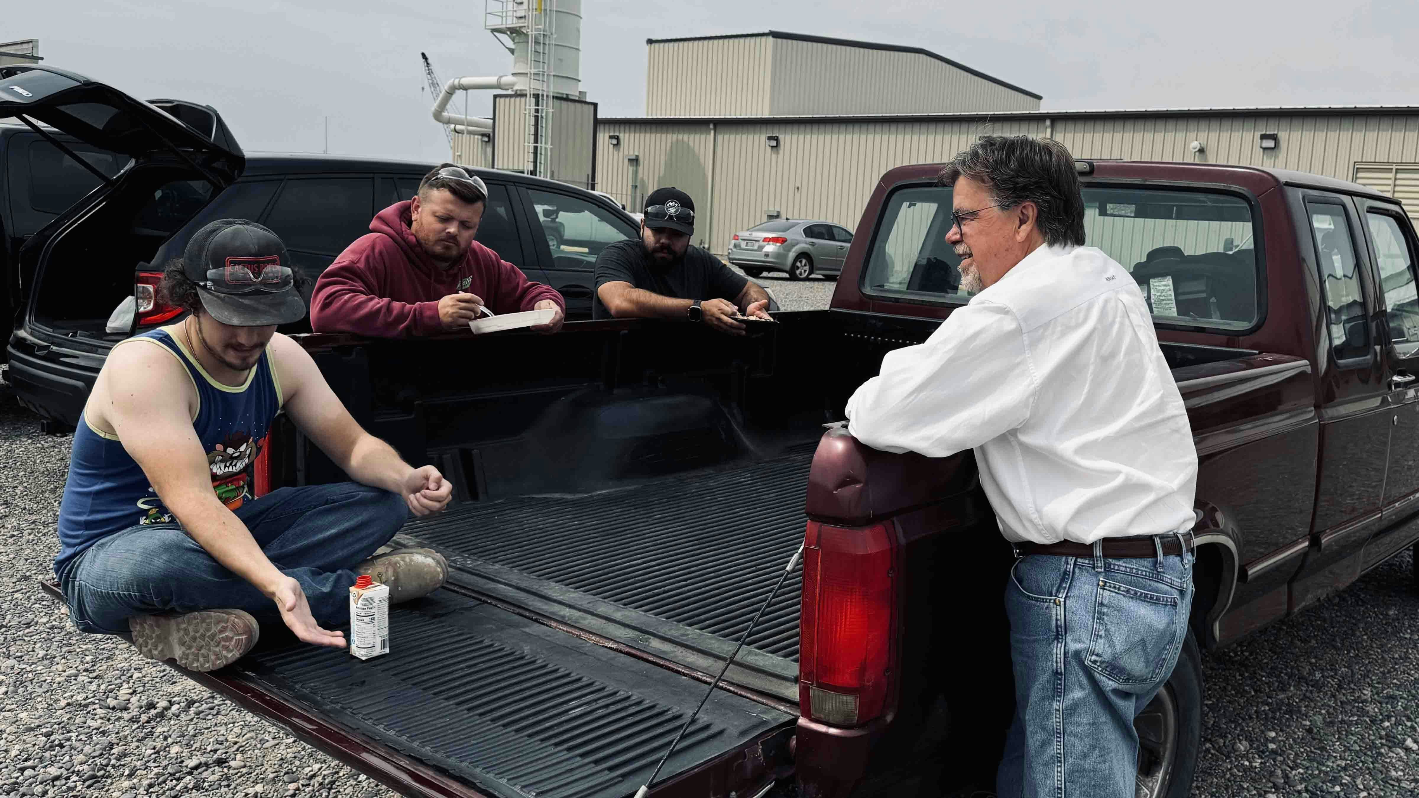 Wyo-Ben Inc. CEO David Brown chats with some of the workers taking a break at a newly constructed cat litter processing plant in Billings, Montana, where he explains the cat litter packaging process.