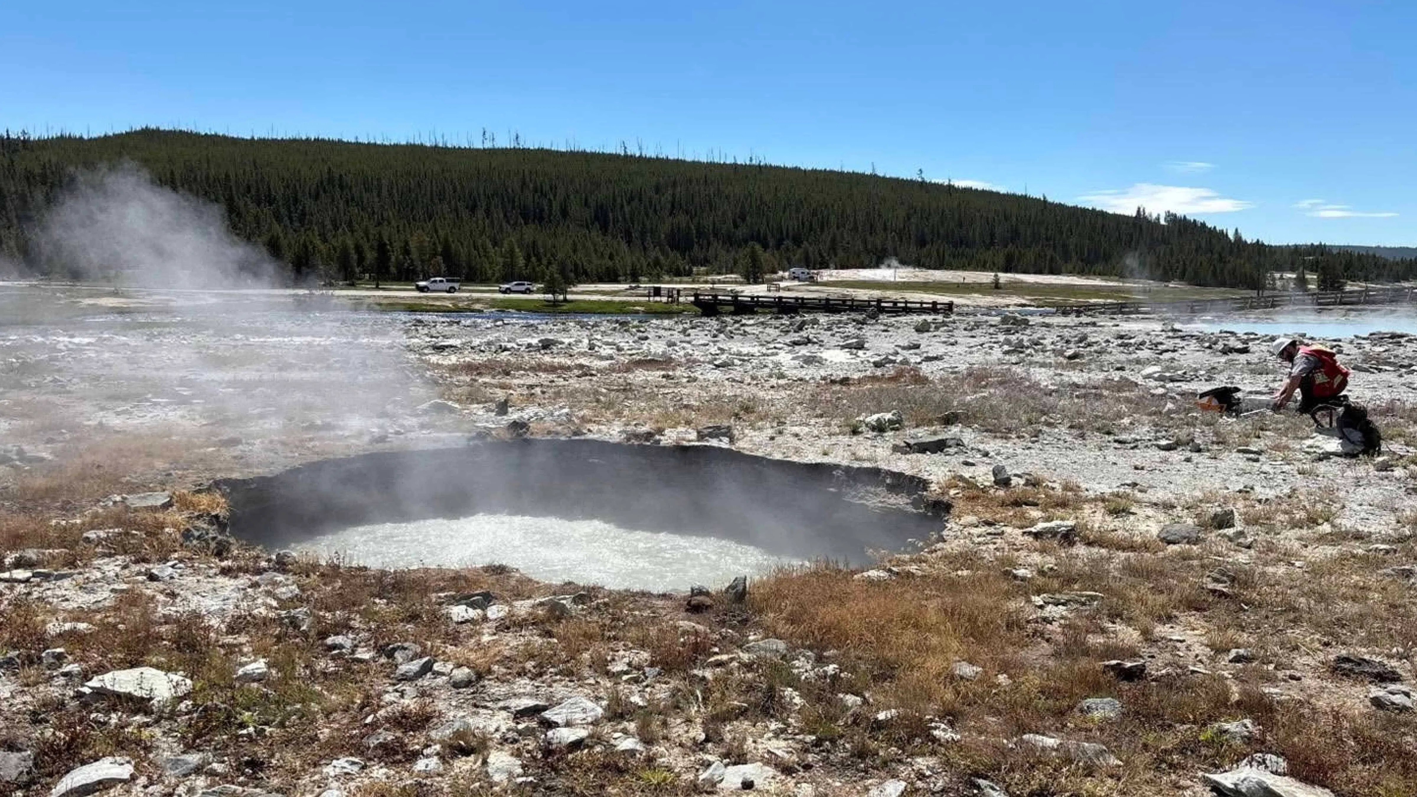 The boiling water-filled crater created by a hydrothermal explosion in Yellowstone National Park's Biscuit Basin. This explosion occurred 100 feet away from Black Diamond Pool, which experienced a much larger hydrothermal explosion in July 2024, but wasn't affected by this incident on June 13.