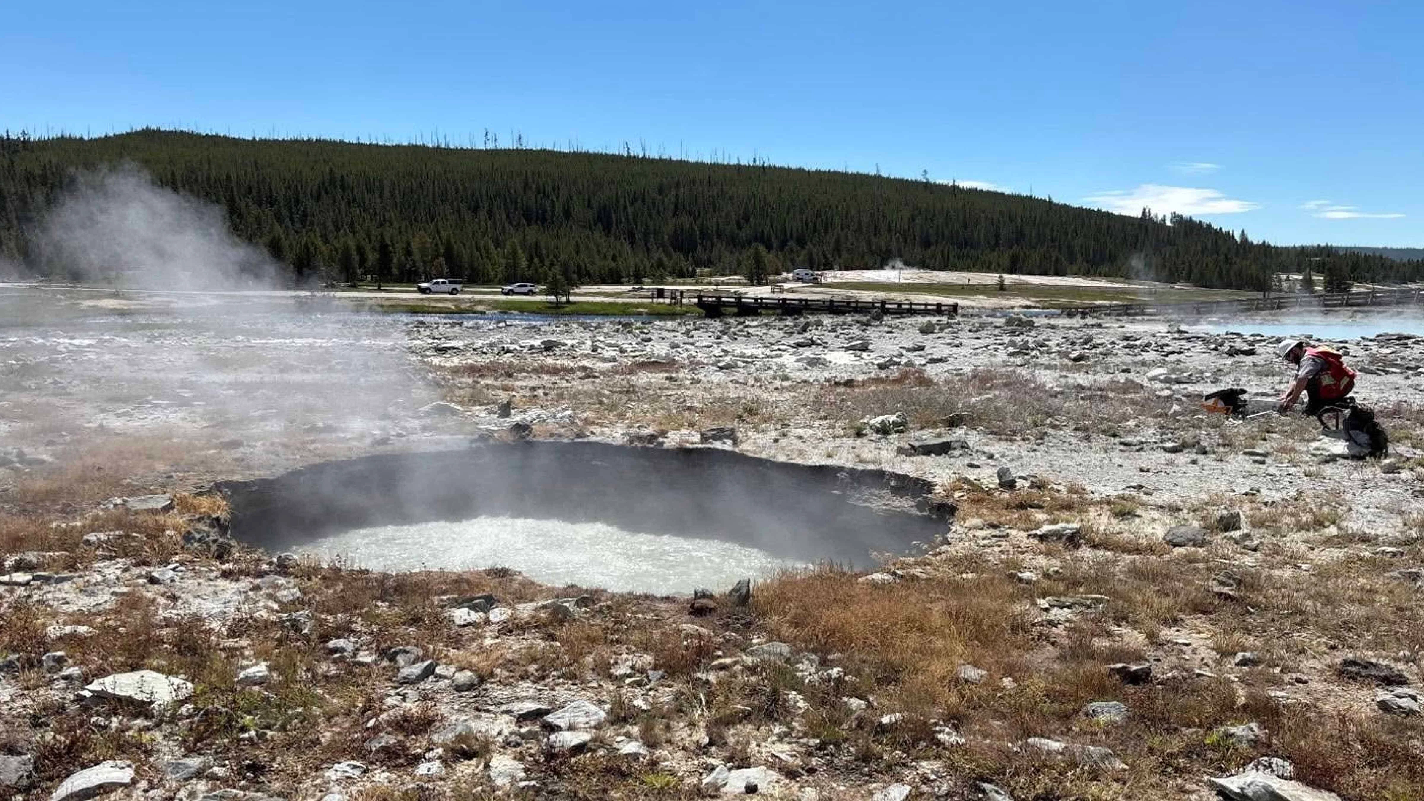 The boiling water-filled crater created by a hydrothermal explosion in Yellowstone National Park's Biscuit Basin. This explosion occurred 100 feet away from Black Diamond Pool, which experienced a much larger hydrothermal explosion in July 2024, but wasn't affected by this incident on June 13.