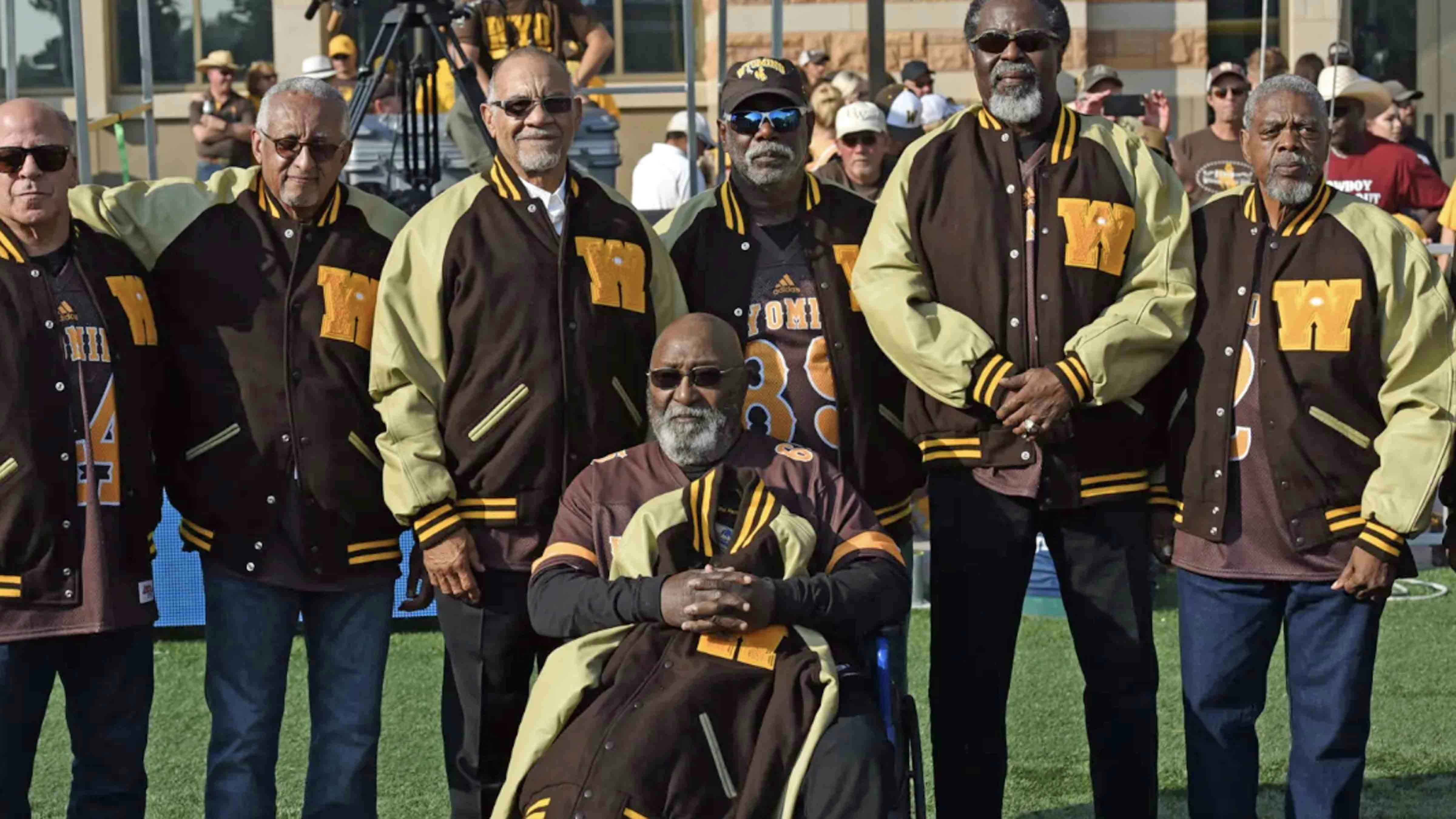 Surviving members of the Black 14 at the University of Wyoming in 2019. From left to right, Tony Gibson, John Griffin, Lionel Grimes, Ron Hill, Tony McGee, Ted Williams and Mel Hamilton in front. (UW Athletic Department)