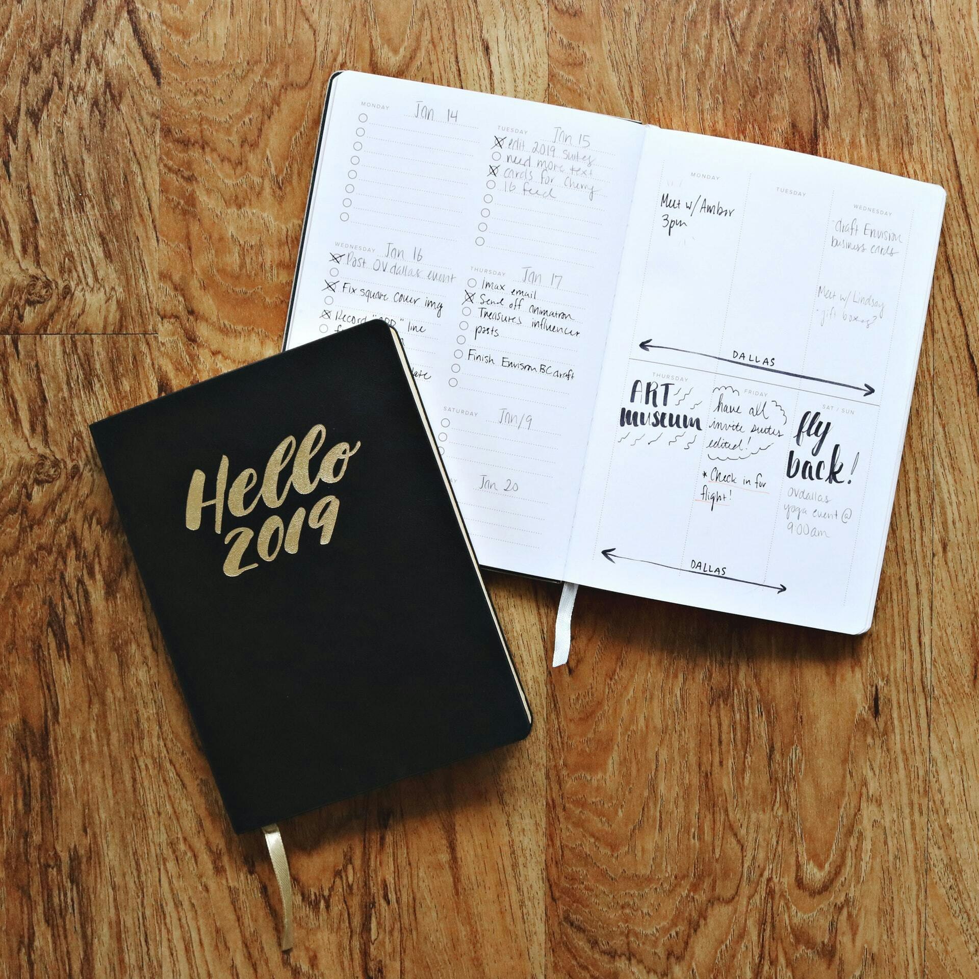Black hello 2019 notebook on brown wooden surface 1937337