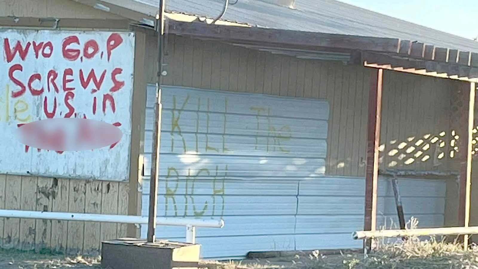 A message attacking the Wyoming Republican Party was among the political statements painted on the old Lazy 8, which also serves as a rural school bus stop. Two men were painting over some of the profanity Monday afternoon.