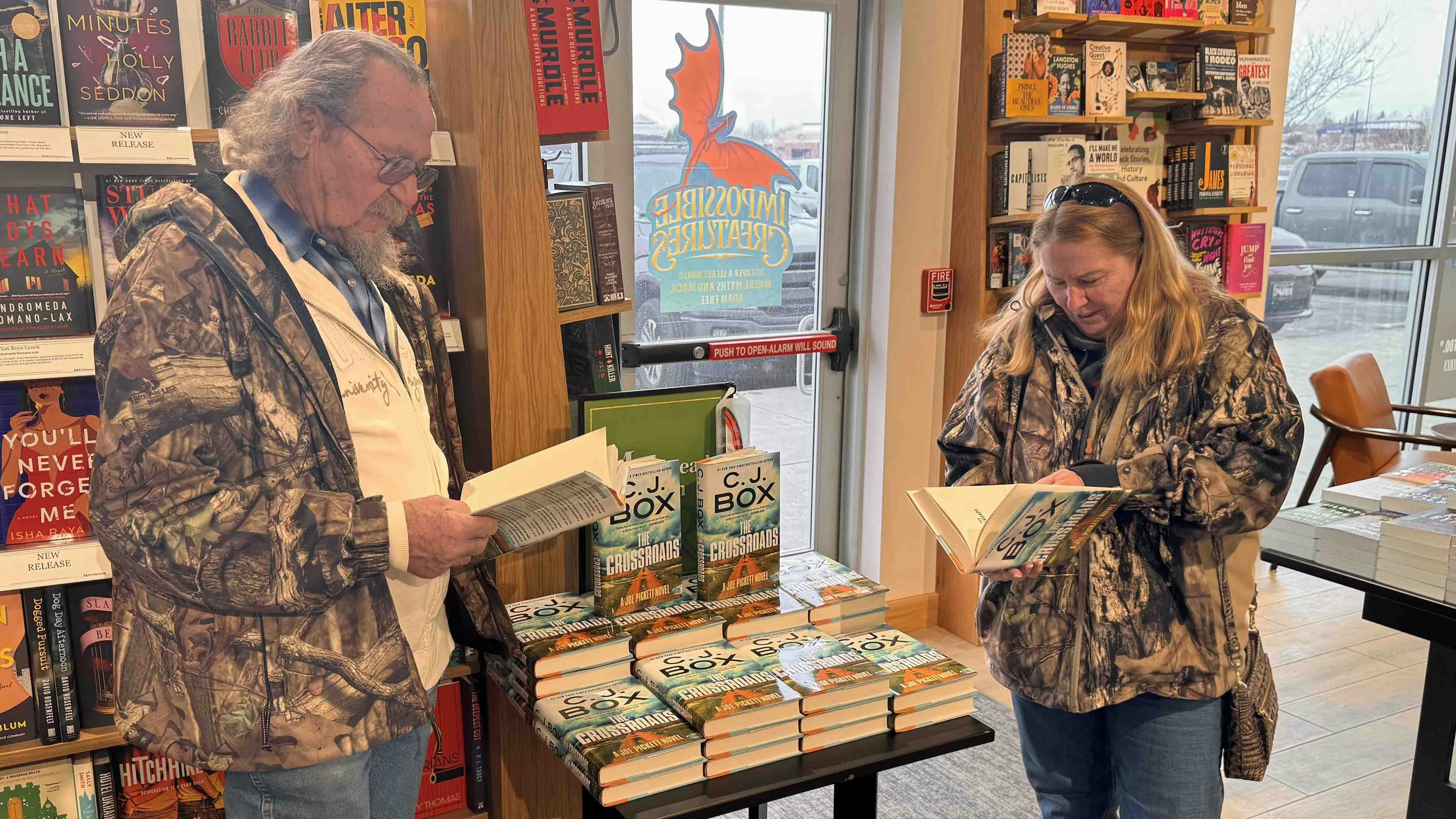 Ralph and Laurie Hammond, both self-described “huge” C.J. Box fans look through his new novel “The Crossroads” at the Cheyenne Barnes & Noble store on Friday, Feb. 20, 2026.