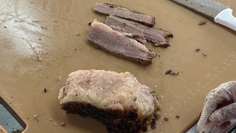 Preparing the brisket sandwich at Cheyenne Frontier Days. Concessionaire Nate Janousek says the brisket is his favorite.
