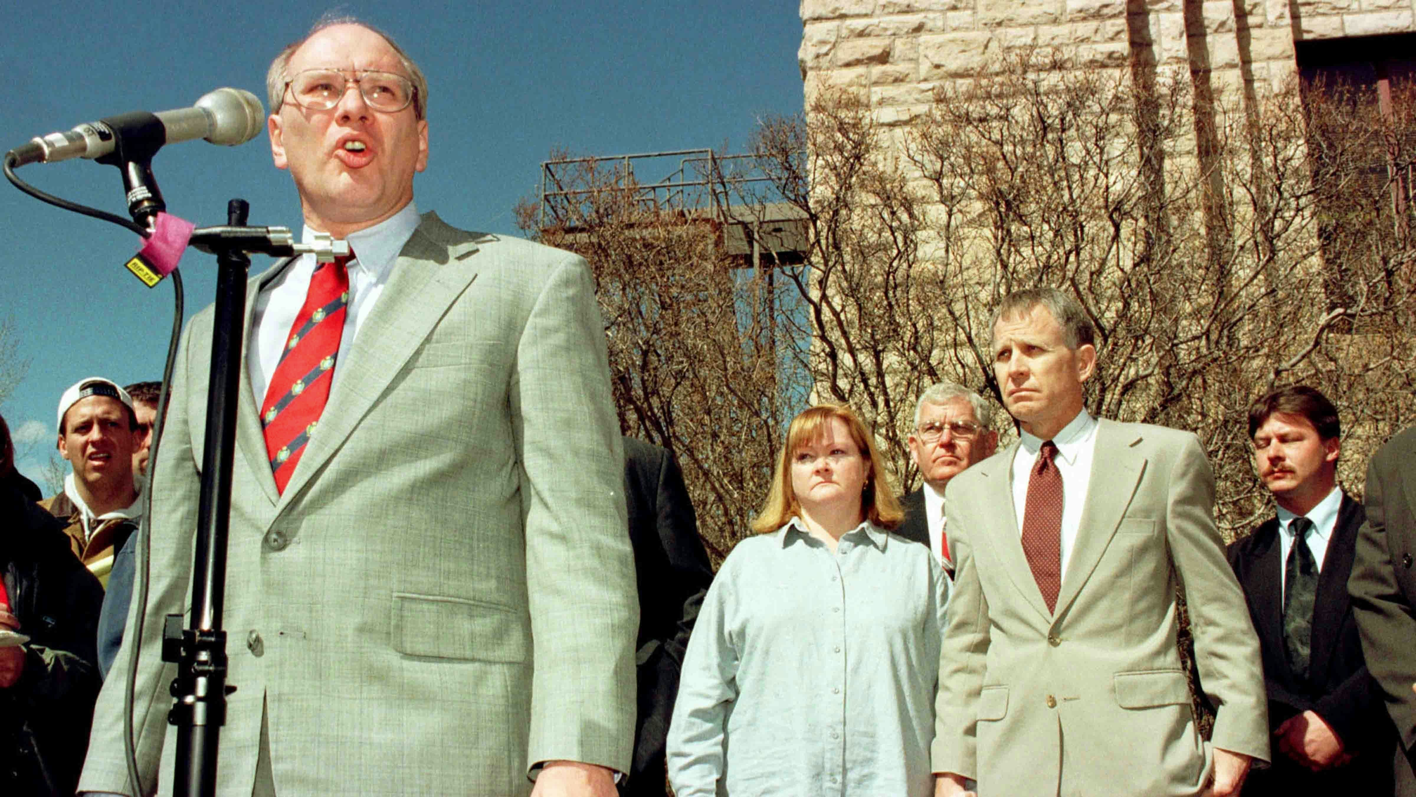 FILE PHOTO: Prosecutor Cal Rerucha makes a statement as Judy and Dennis Shepard, parents of murder victim Matthew Shepard, stand quietly following the sentencing of Russell Henderson in their son's murder. (photo by