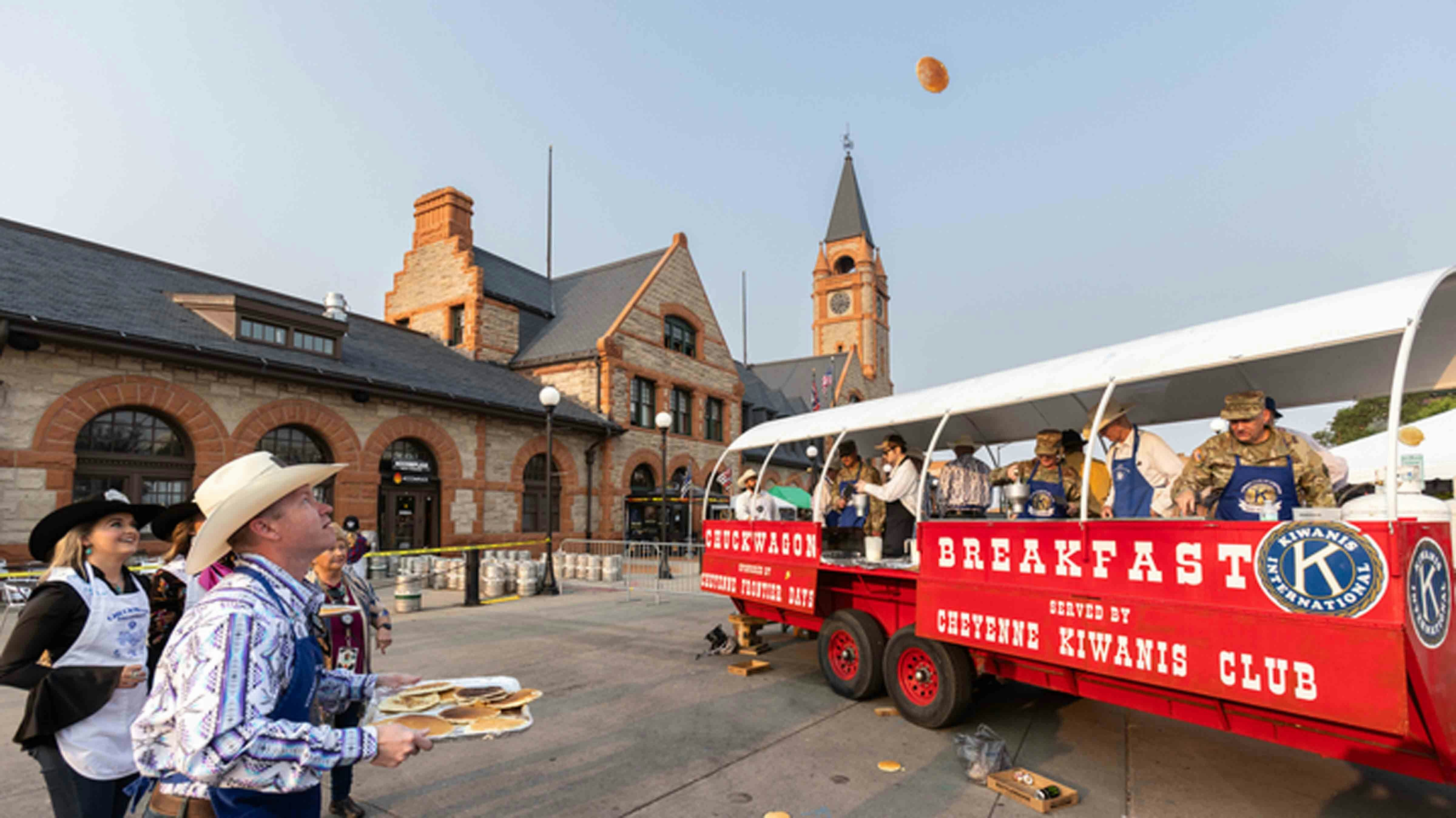 Pancakes fly at the Cheyenne Frontier Days Pancake Breakfast in downtown Cheyenne, Wyoming on July 22, 2024.