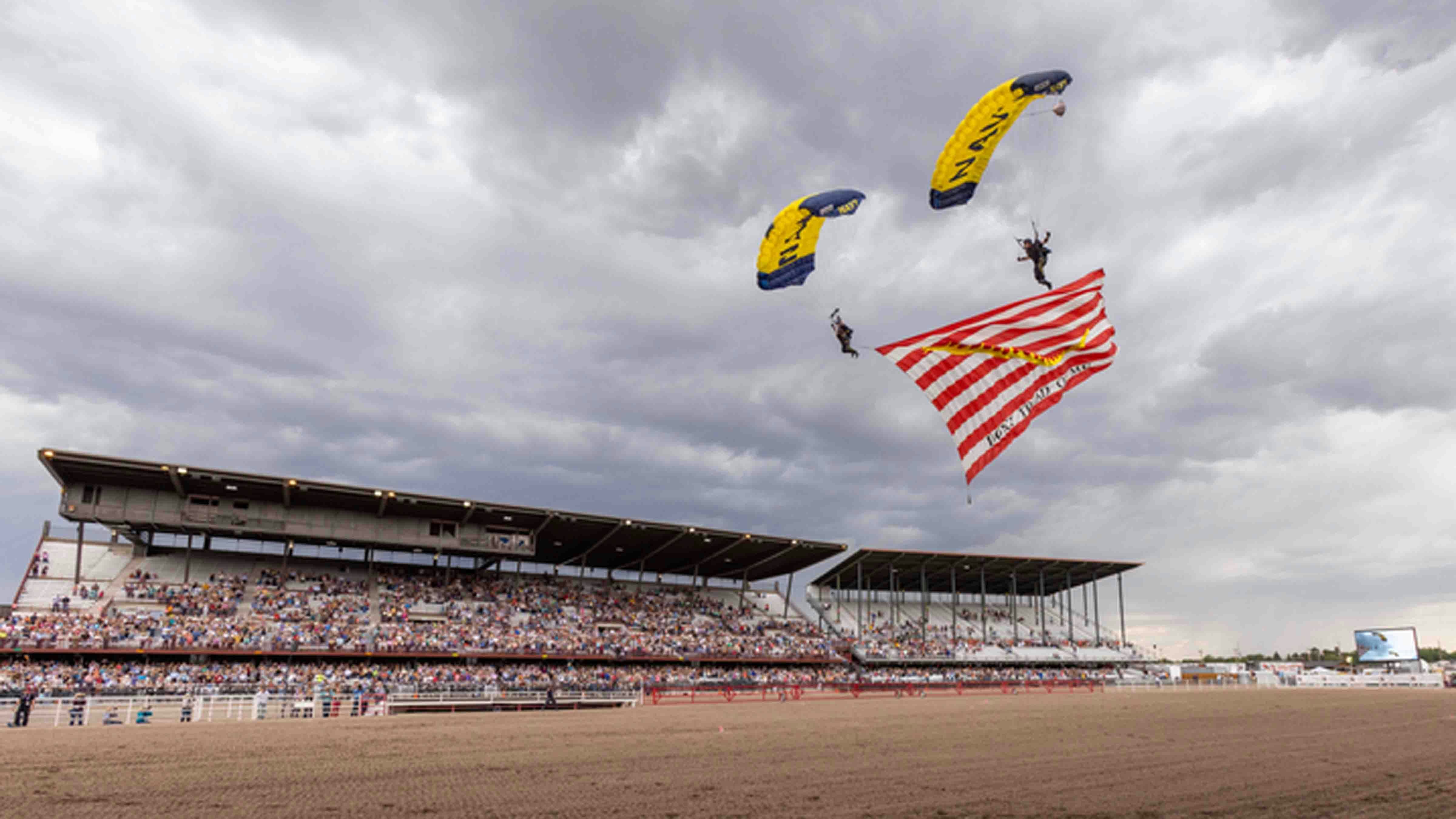 The Navy Leap Frog team parachutes into the arena on July 26, 2024 at Cheyenne Frontier Days.