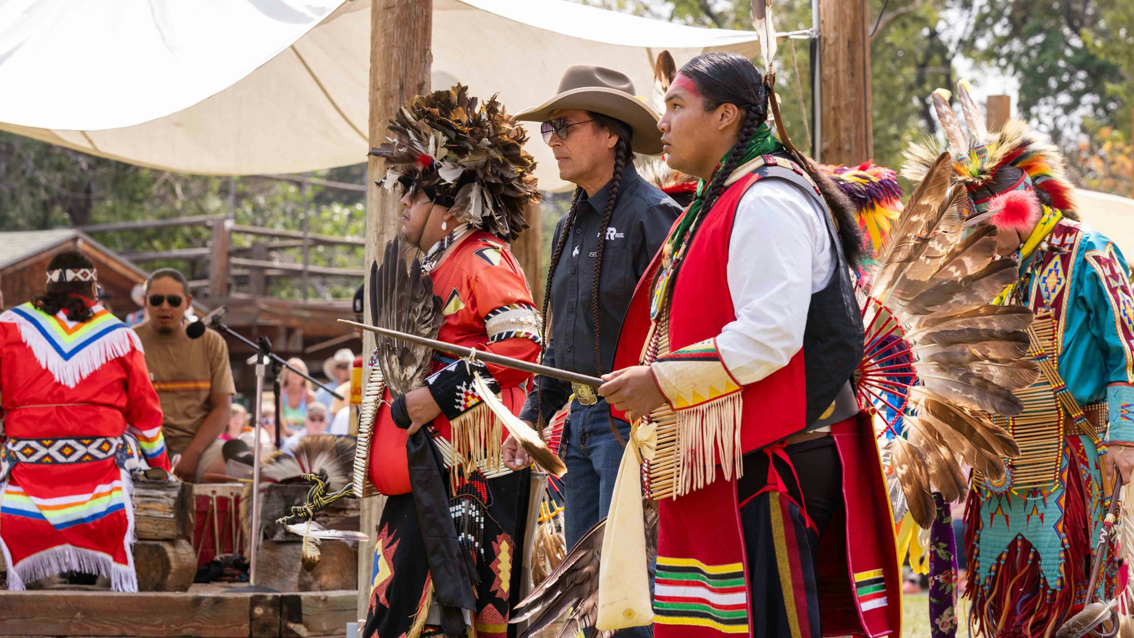 Mo Brings Plenty, actor in the TV show Yellowstone dances with dancers at the Native American Indian Village at Cheyenne Frontier Days on July 22, 2024.