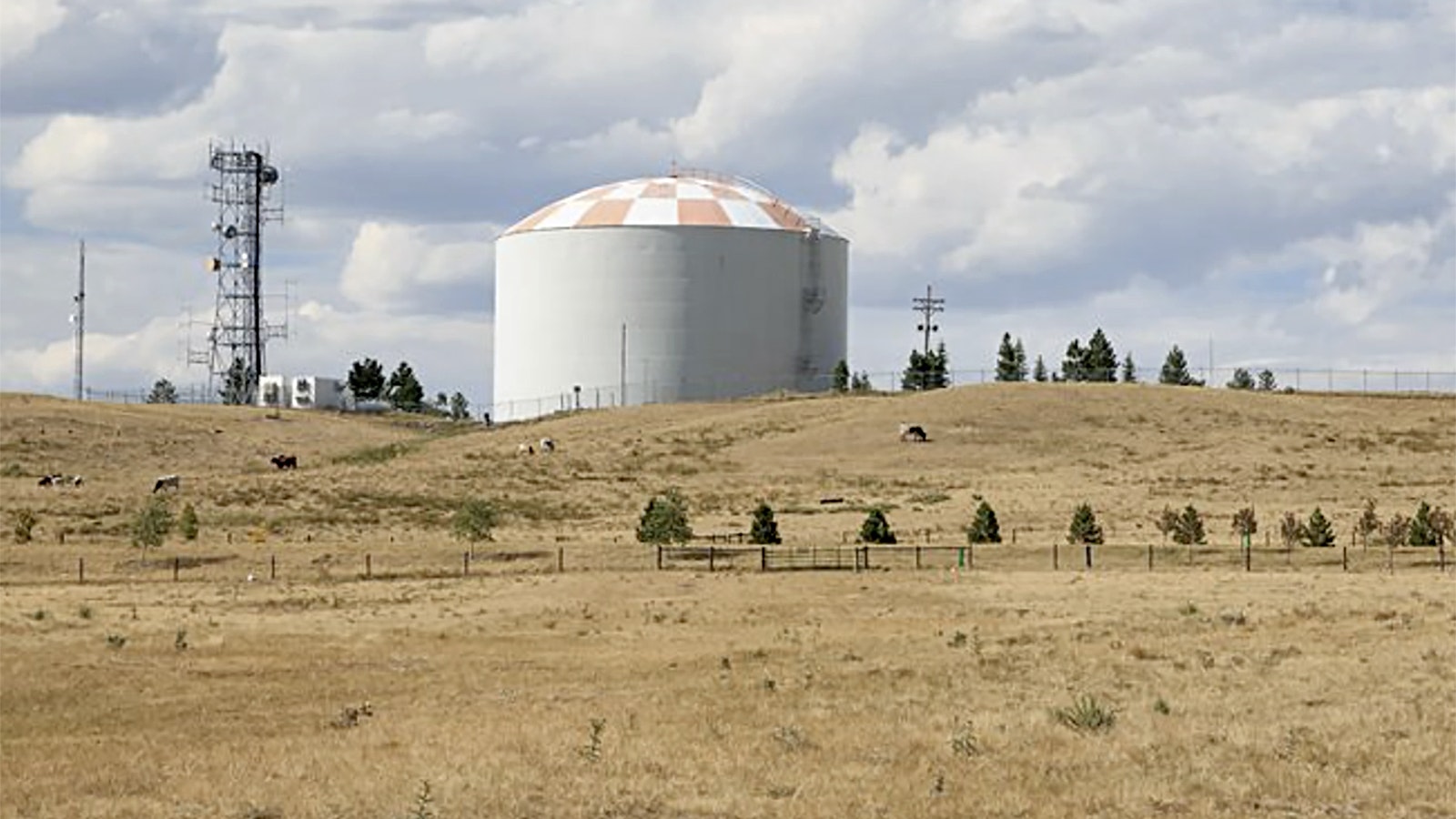 A water tower stands over dry grass north of Cheyenne in Laramie County.