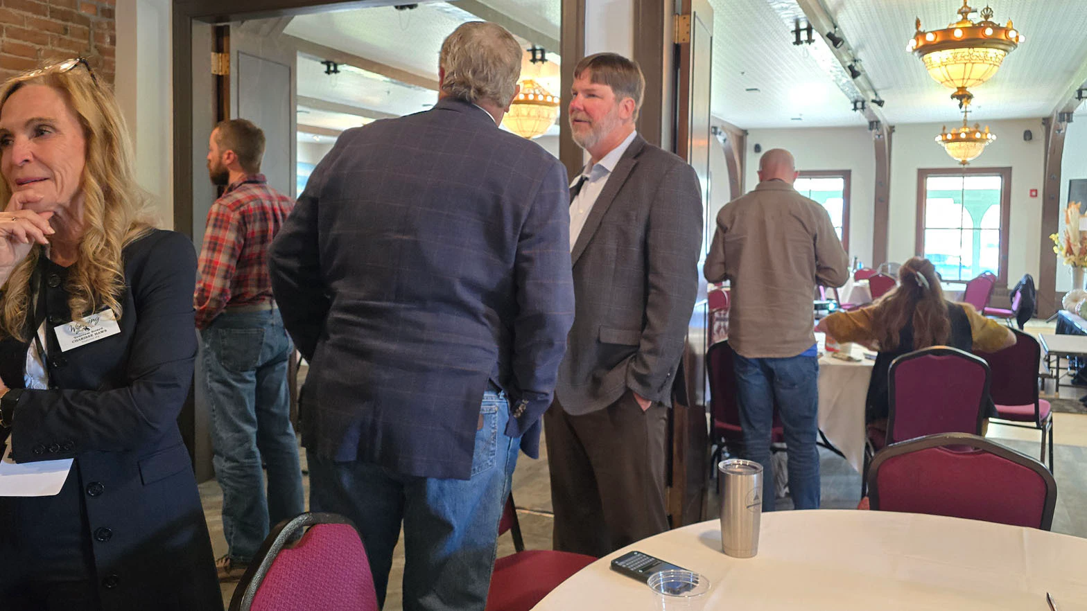 Wyoming Hospitality and Travel Coalition Director Chris Brown talks with Sen. Mike Gierau during the Fall Hospitality and Tourism Summit in Sheridan.