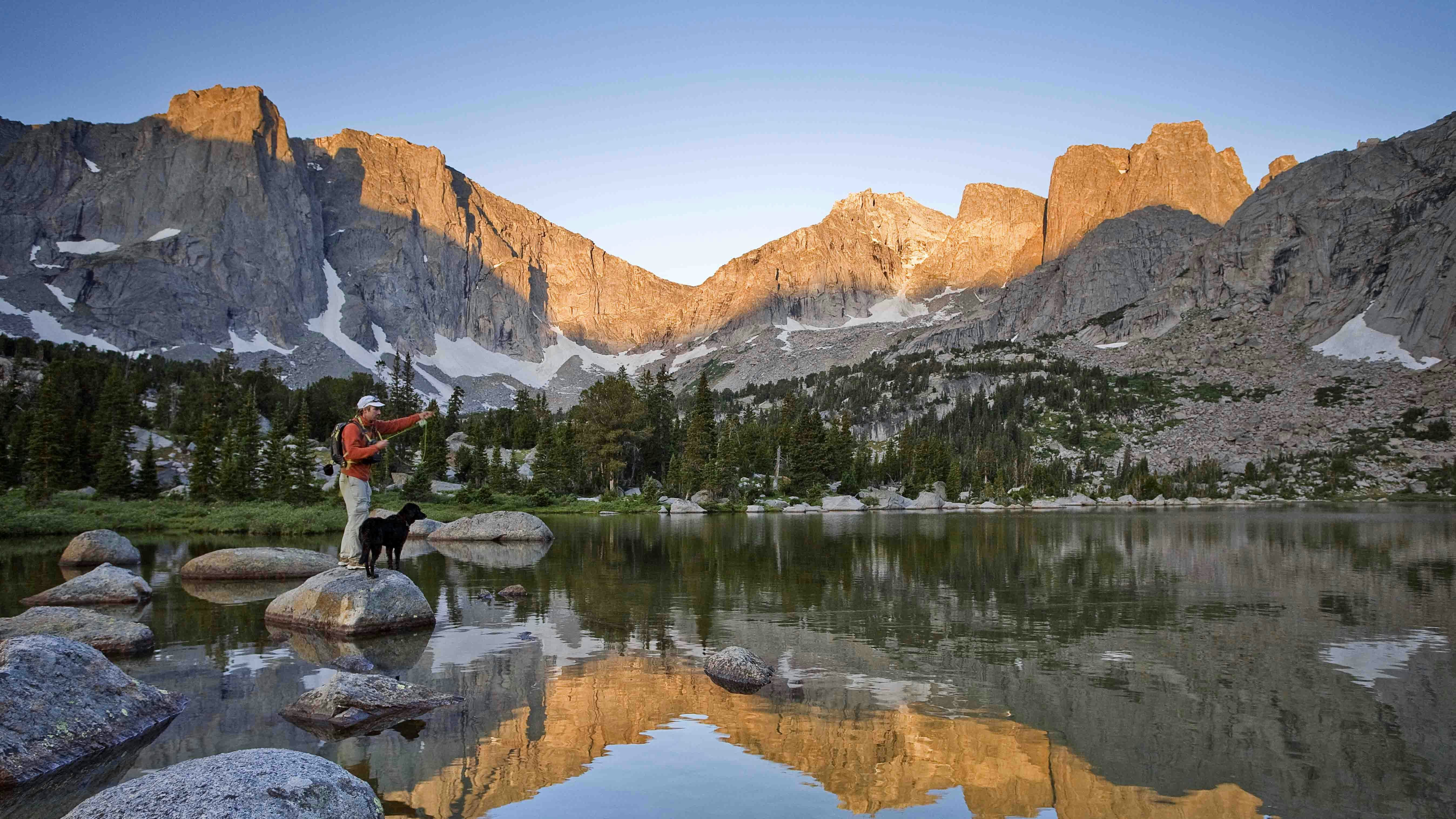 Fly fisherman in a lake below the Cirque of the Towers, Wind River Range, Wyoming