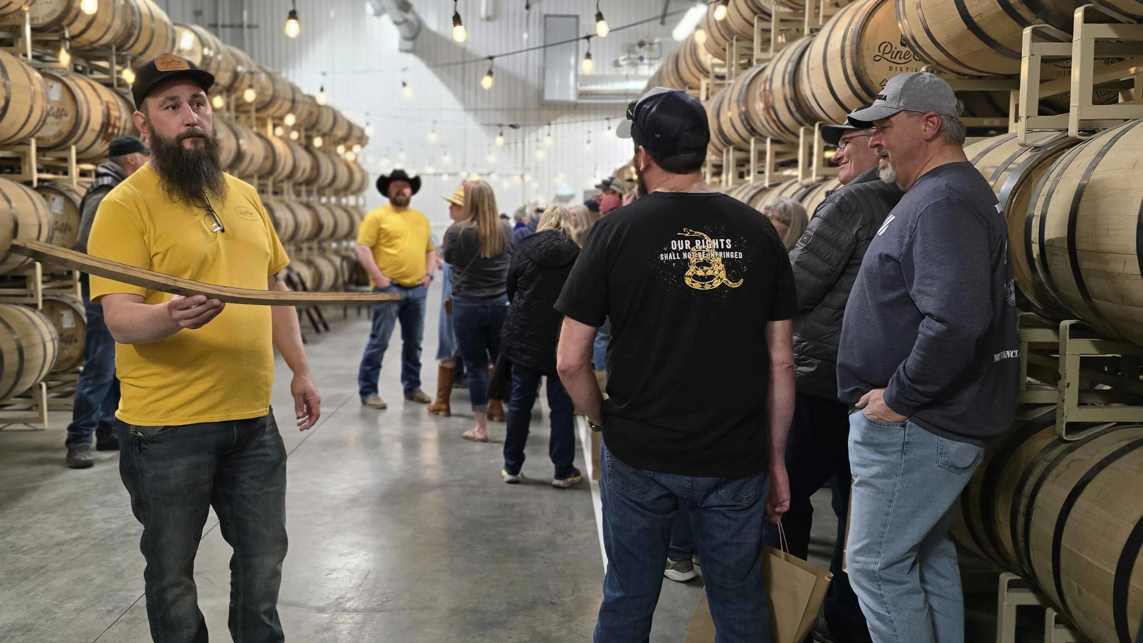 As people waited in line, Pine Bluffs Distilling employee Mitch Braaten talks about the aging process for Romanowksi Rye during an event that attracted hundreds of Joe Pickett fans and raised $40,000 for the Wyoming Hunger Initiative.