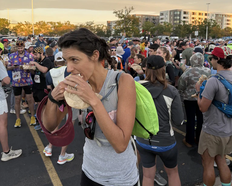 Cowboy State Daily's Clair McFarland ate the first taco of The Loco Strikes Back Taco Bell 50K ultramarathon in Denver on Oct. 3, 2026, where runners have to make stops at 11 Taco Bells along a 31-mile run and eat a menu item at 10 of them.