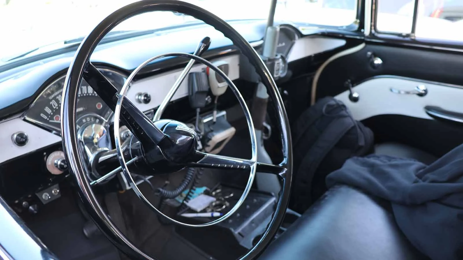 The interior of the 1955 Chevy police cruiser features a fake shotgun, radio, and working lights and siren. 