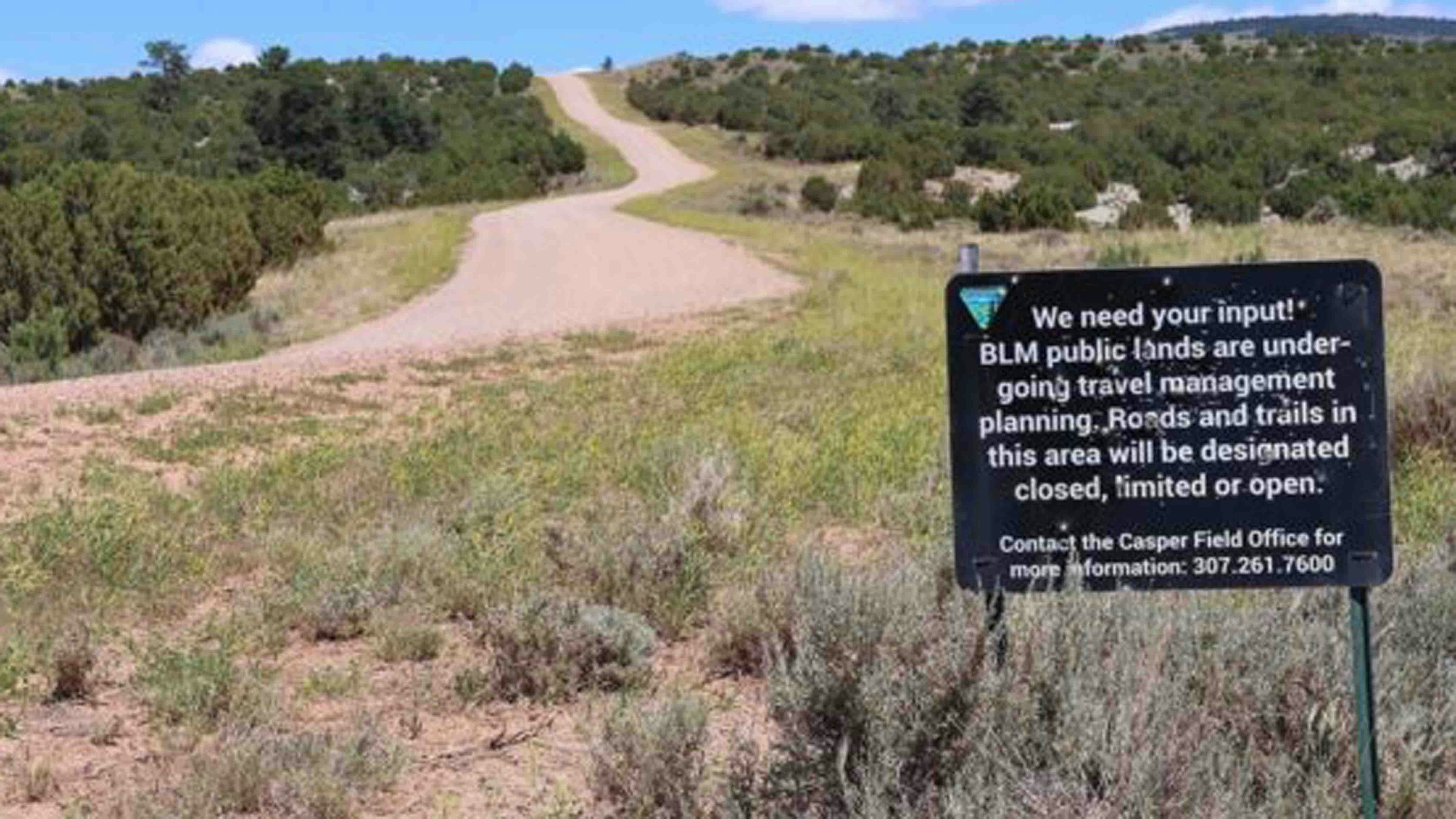 A BLM sign sits beside Circle Drive or County Road 505 south of Casper Mountain asking for input about BLM trails on its lands.