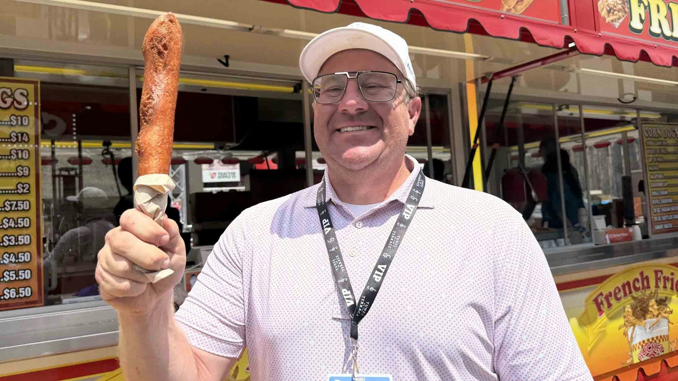 Nate Janousek, whose company Fun Biz is the exclusive concessionaire for Cheyenne Frontier Days, shows off his rendition of a carnival favorite -- the corn dog.