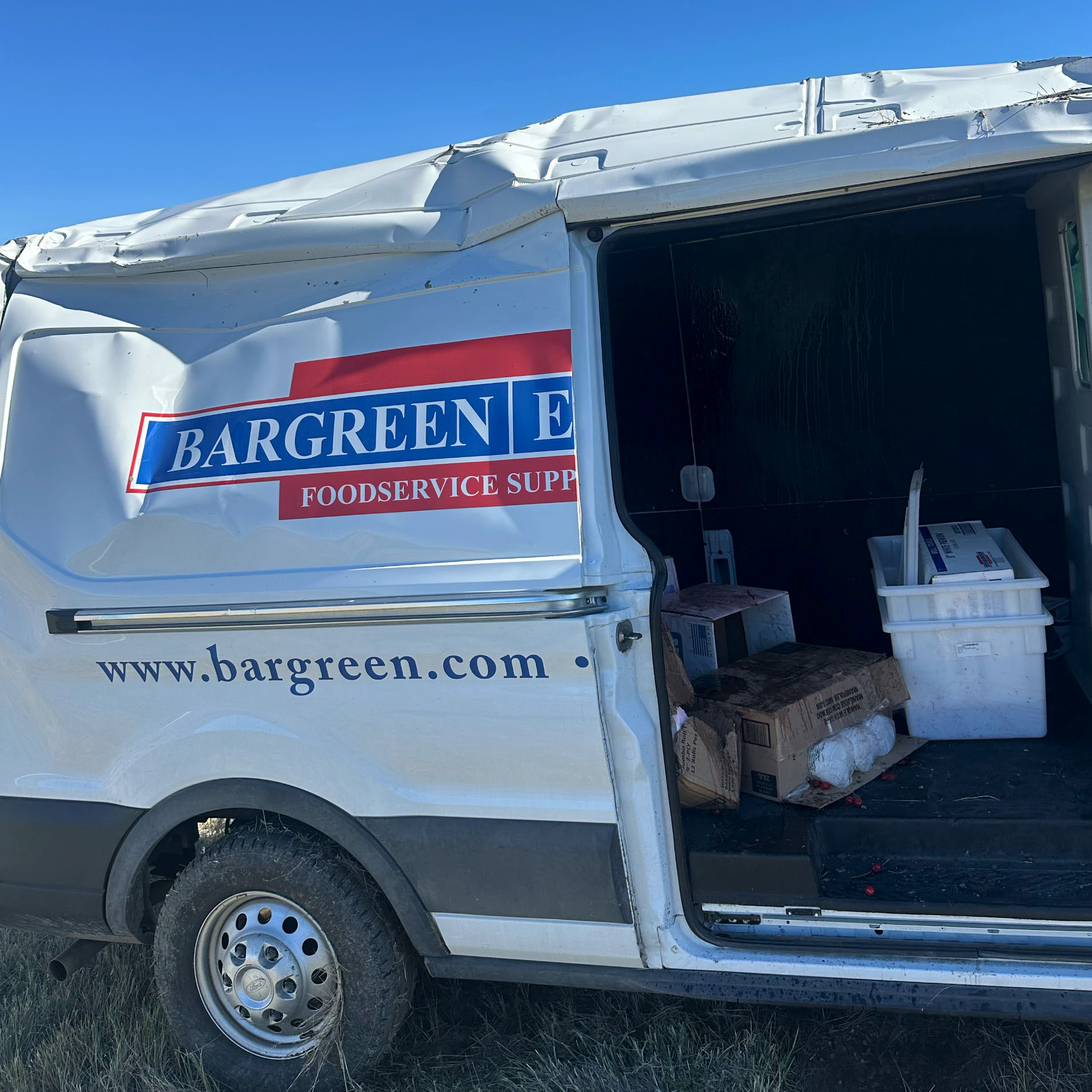 The Bargreen Ellingson delivery van sits heavily damaged after rolling along Interstate 25 north of Casper on Friday.