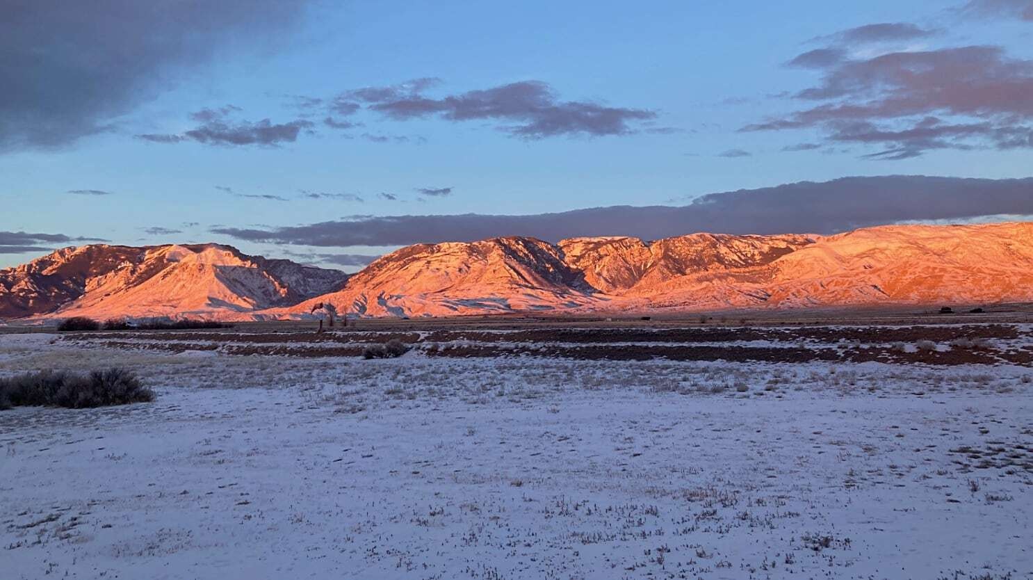 "Sunrise with an edging of virga. The Absarokas near Clark’s Fork Canyon. The Absarokas to the north of my front yard in Clark."