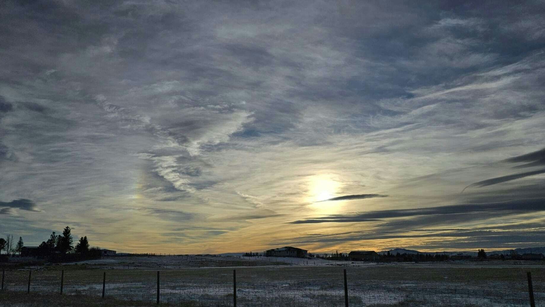 "Pre-sunset Wednesday. Pretty cool clouds with a slight sundog." South of Laramie, WY