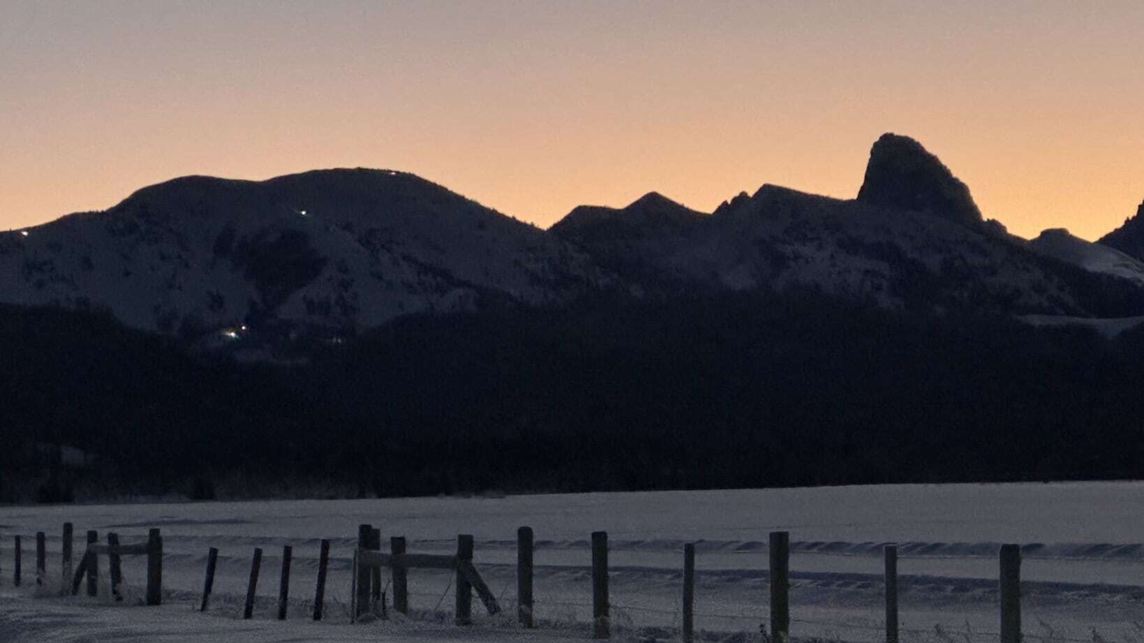 "Teton sunrise in Alta, Wyoming. Snow groomers working at Grand Targhee Ski Resort."