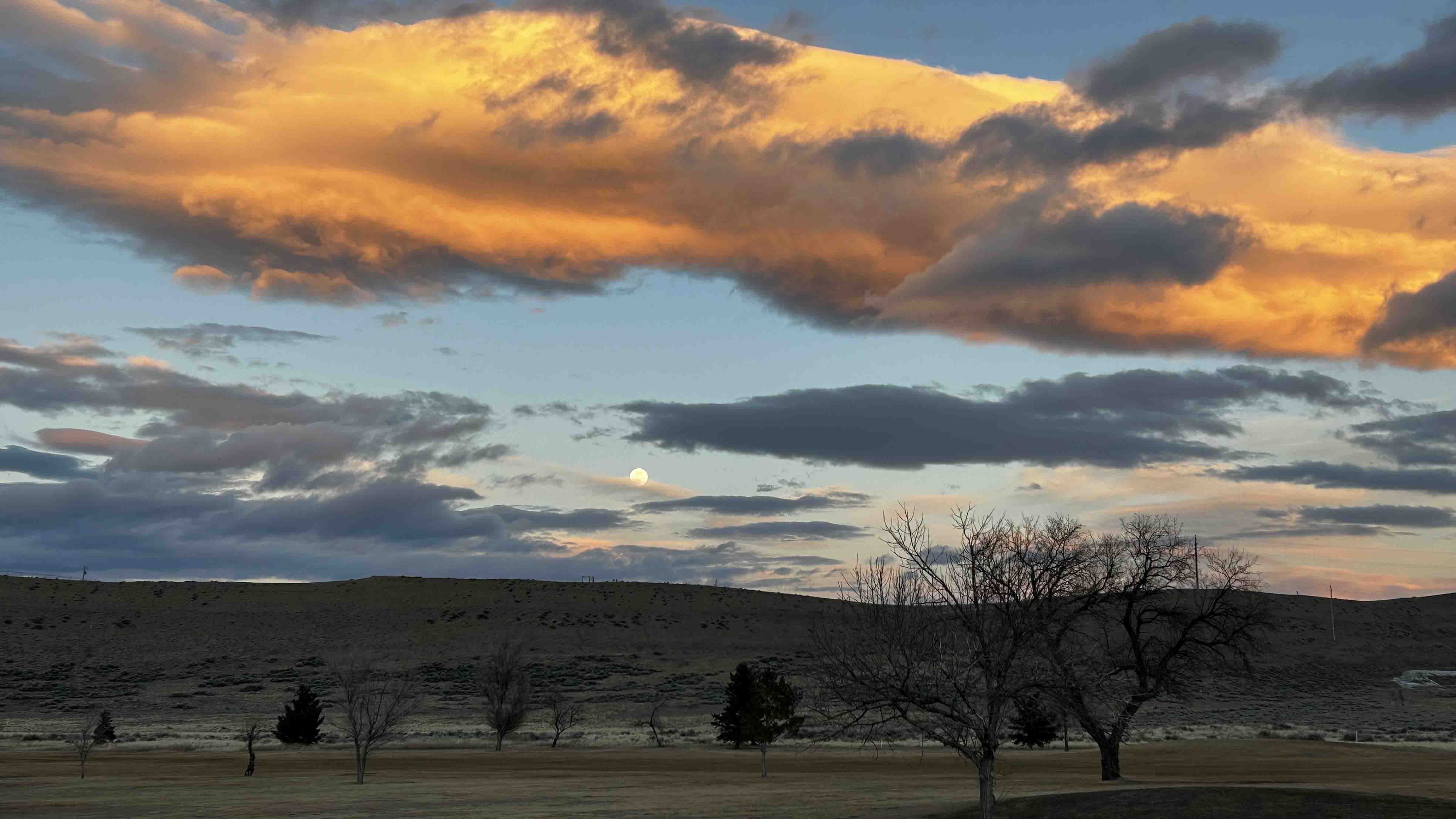 "Moonrise and sunset in Cody from golf course"