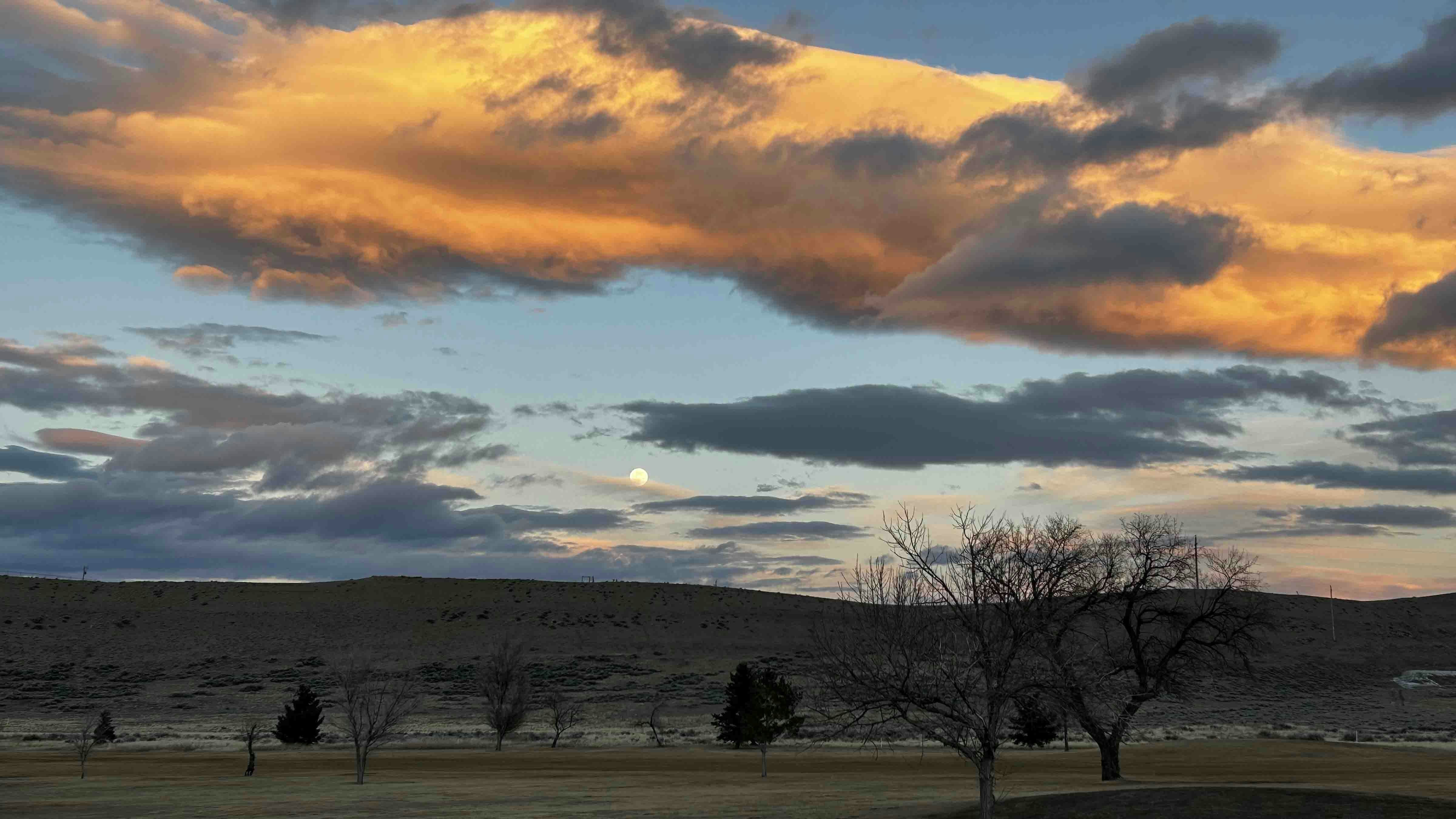 "Moonrise and sunset in Cody from golf course"