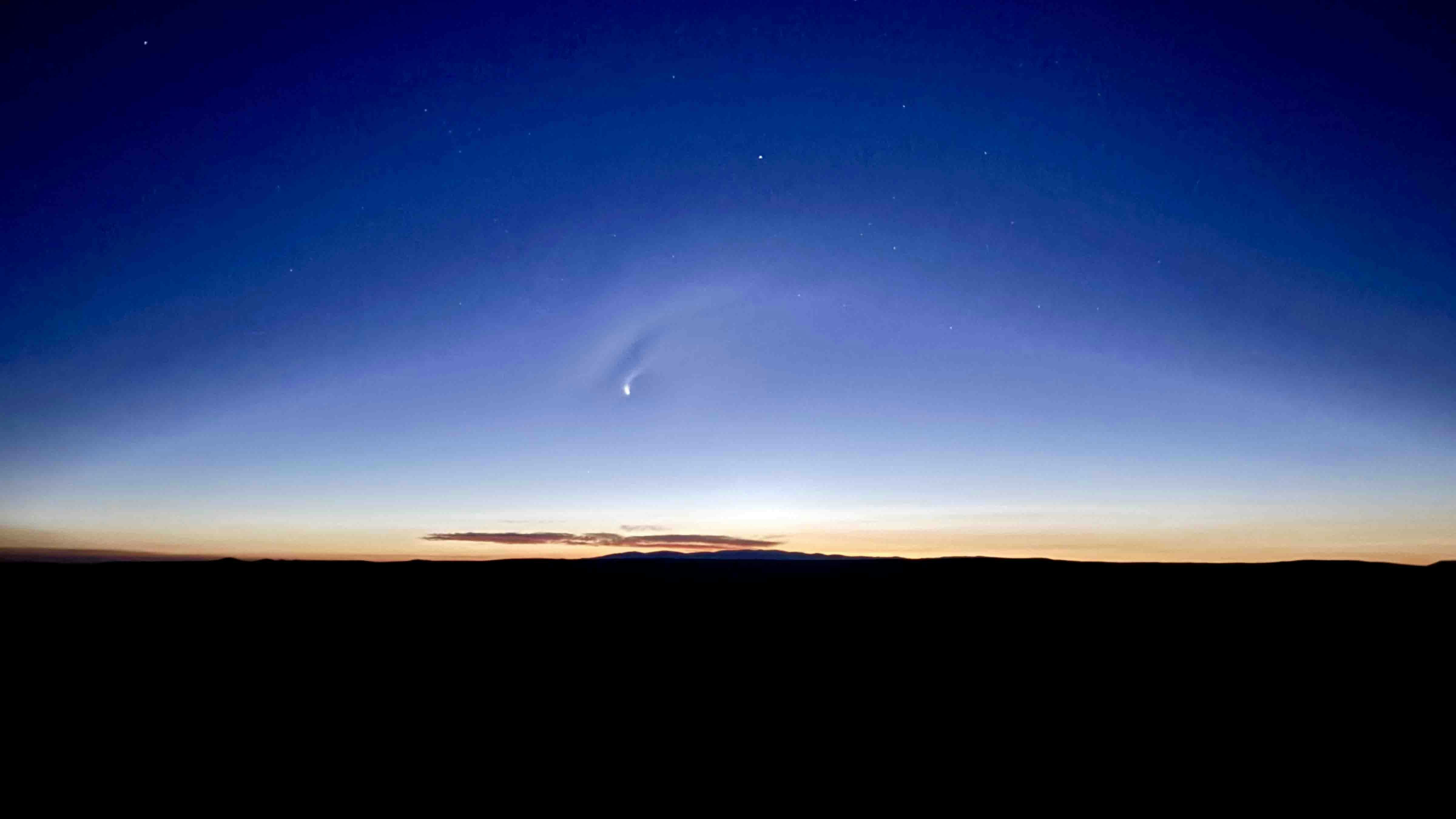 "Sunrise on top of Wild Horse Butte near Baggs with rare comet still visible."