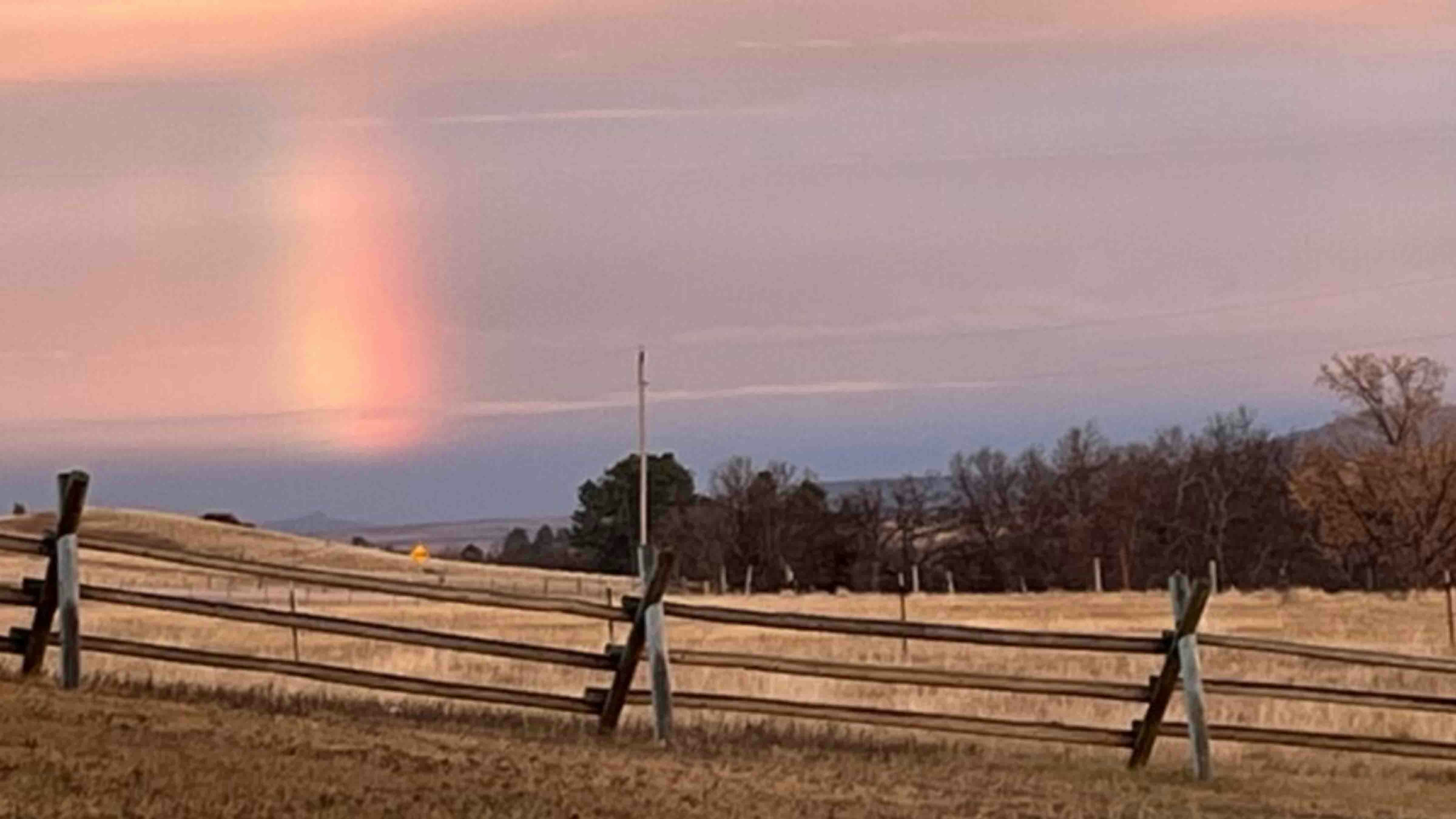 "With a beautiful sunset  to my back in the west, l noticed this strange rainbow about 20 miles east over the Wyo - S Dakota border.