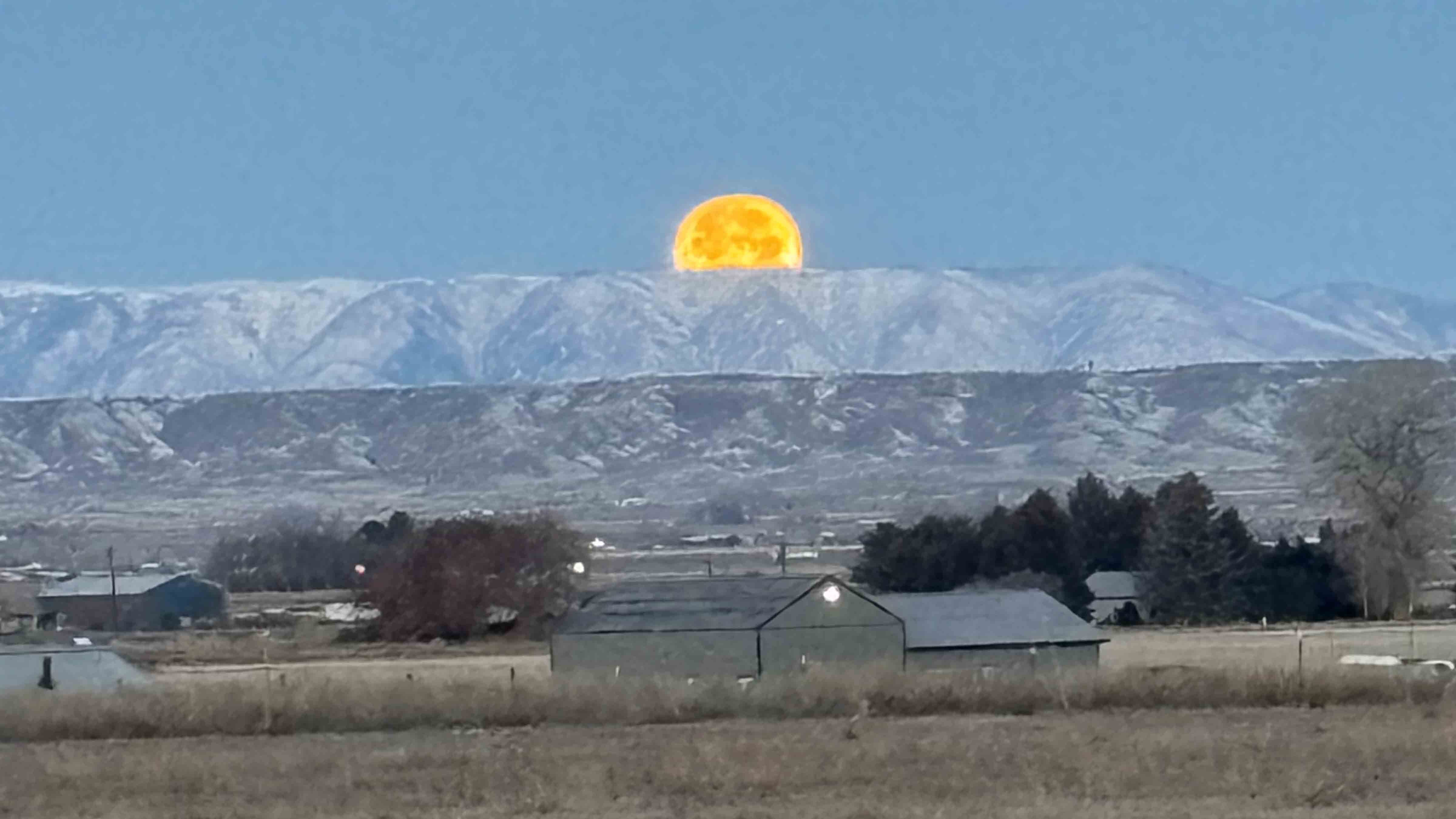 Moon setting in the Powell Valley with Polecat Bench and Beartooth Mountains in background