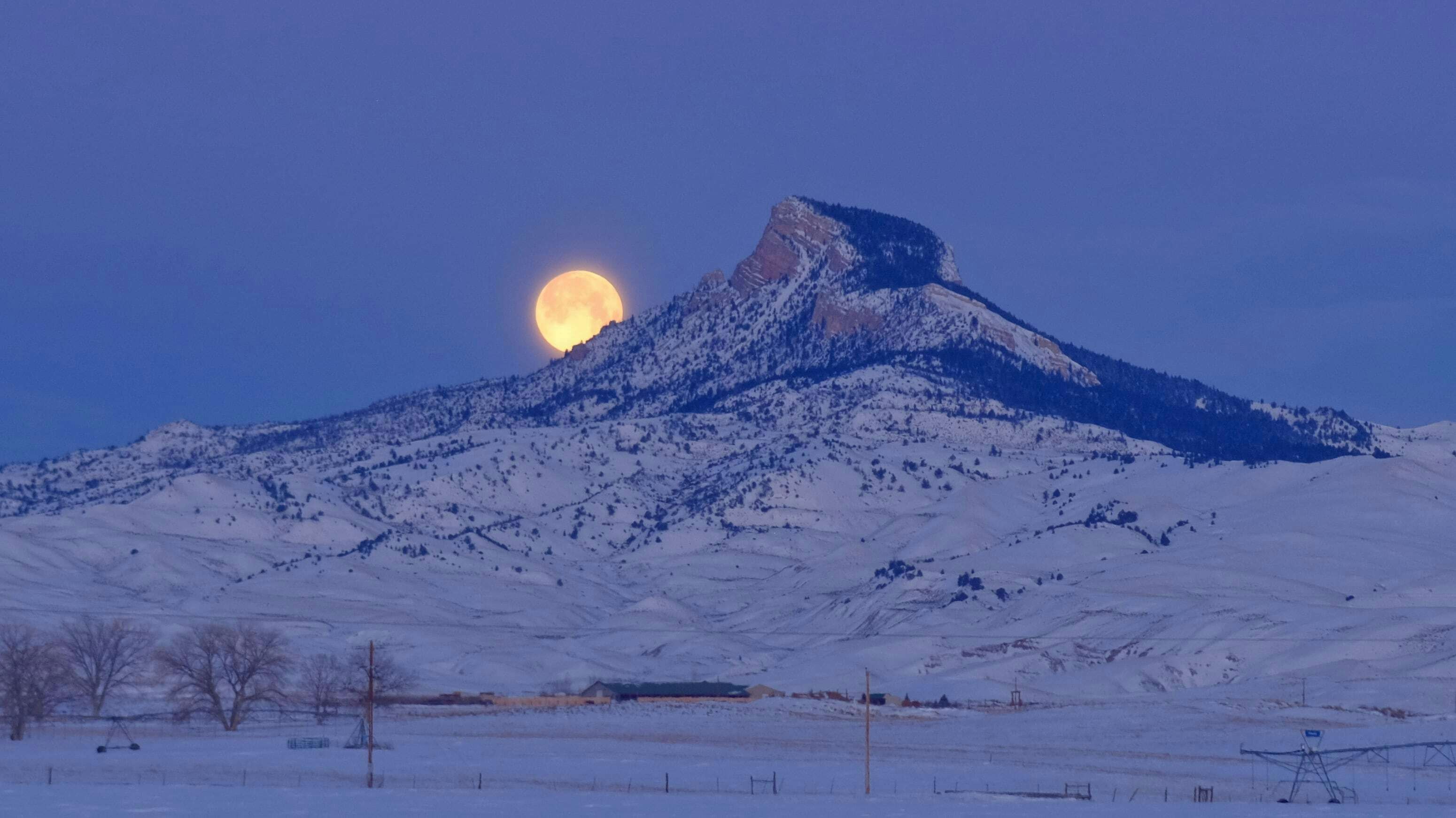 "Just before the sun climbed above the mountains to my east, the moon was setting behind Heart Mountain in Park County. The mountains east and west of me always make for great views of both the sun and moon rising and setting."