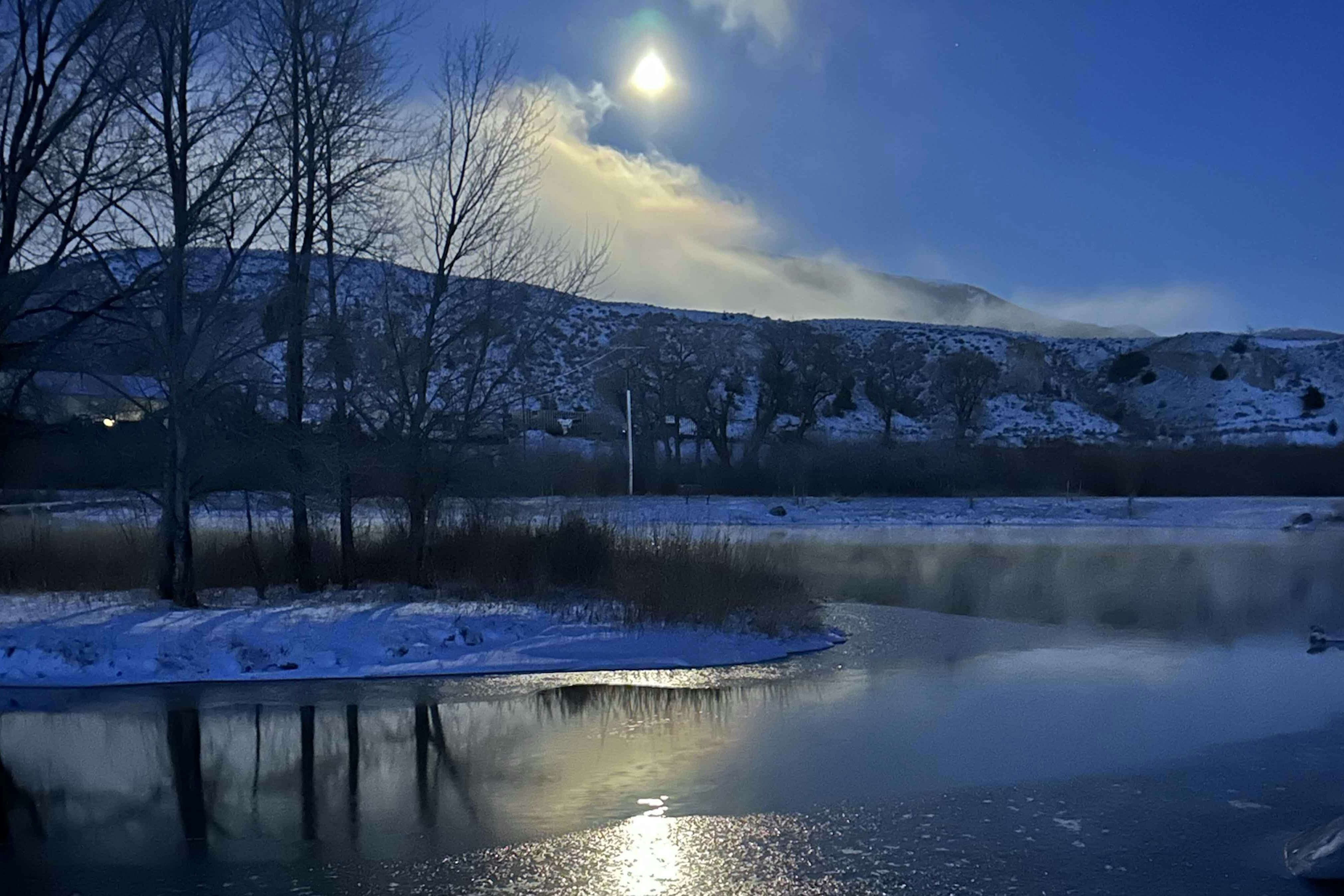 Moon set at sunrise on Pete's pond in Dubois. Frosty 12 degrees on March 26, 2024