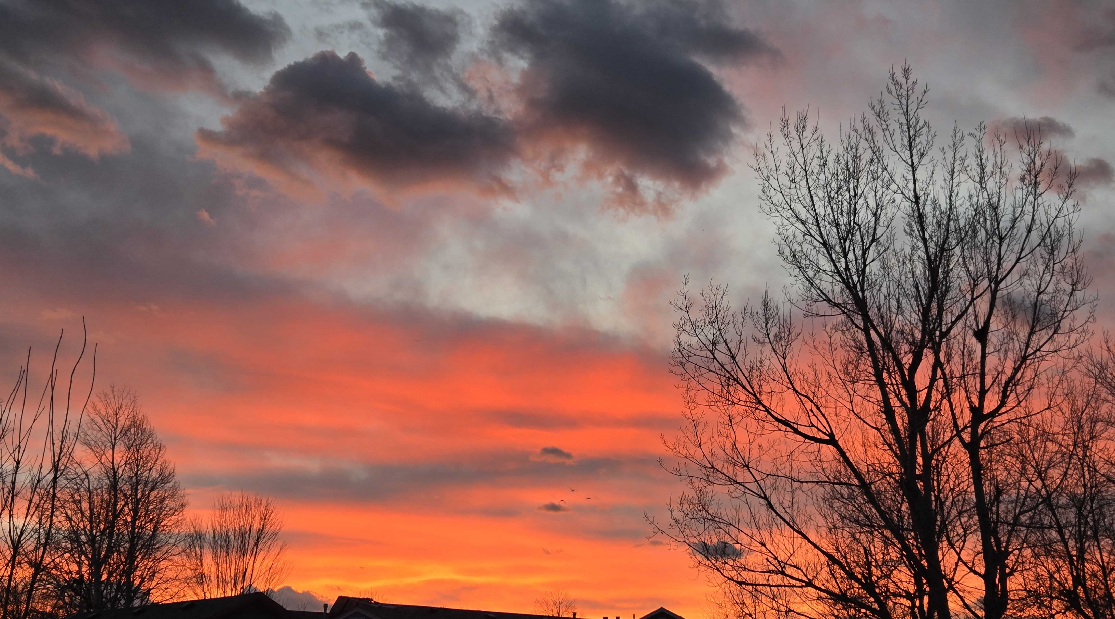 "Sunset over Sheridan. Three ducks flying in the distance."