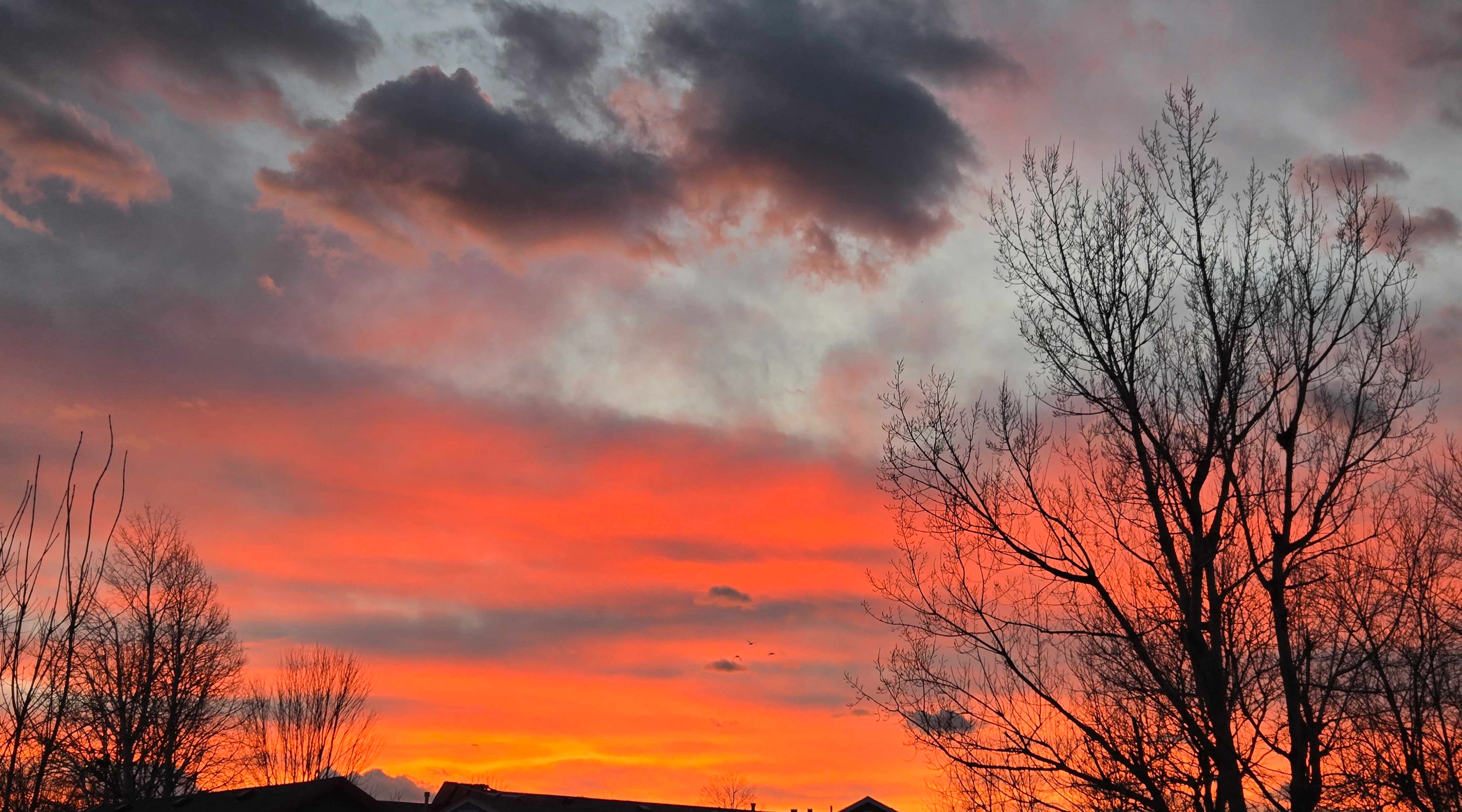 "Sunset over Sheridan. Three ducks flying in the distance."