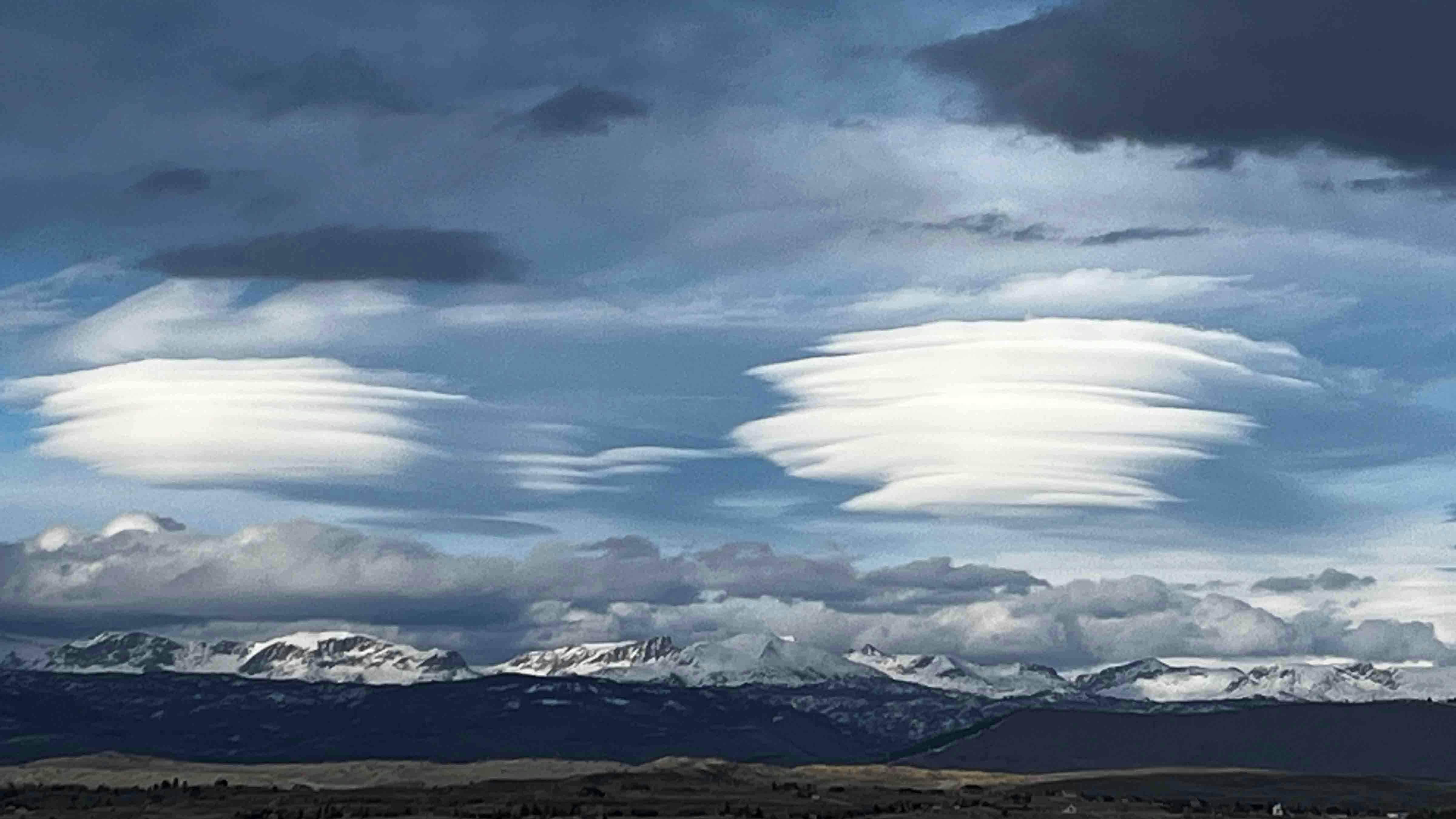 "Lenticular clouds that quickly formed then dissipated just as fast over Wind River mountains just after 7 PM on Tuesday, 4/16/24"
