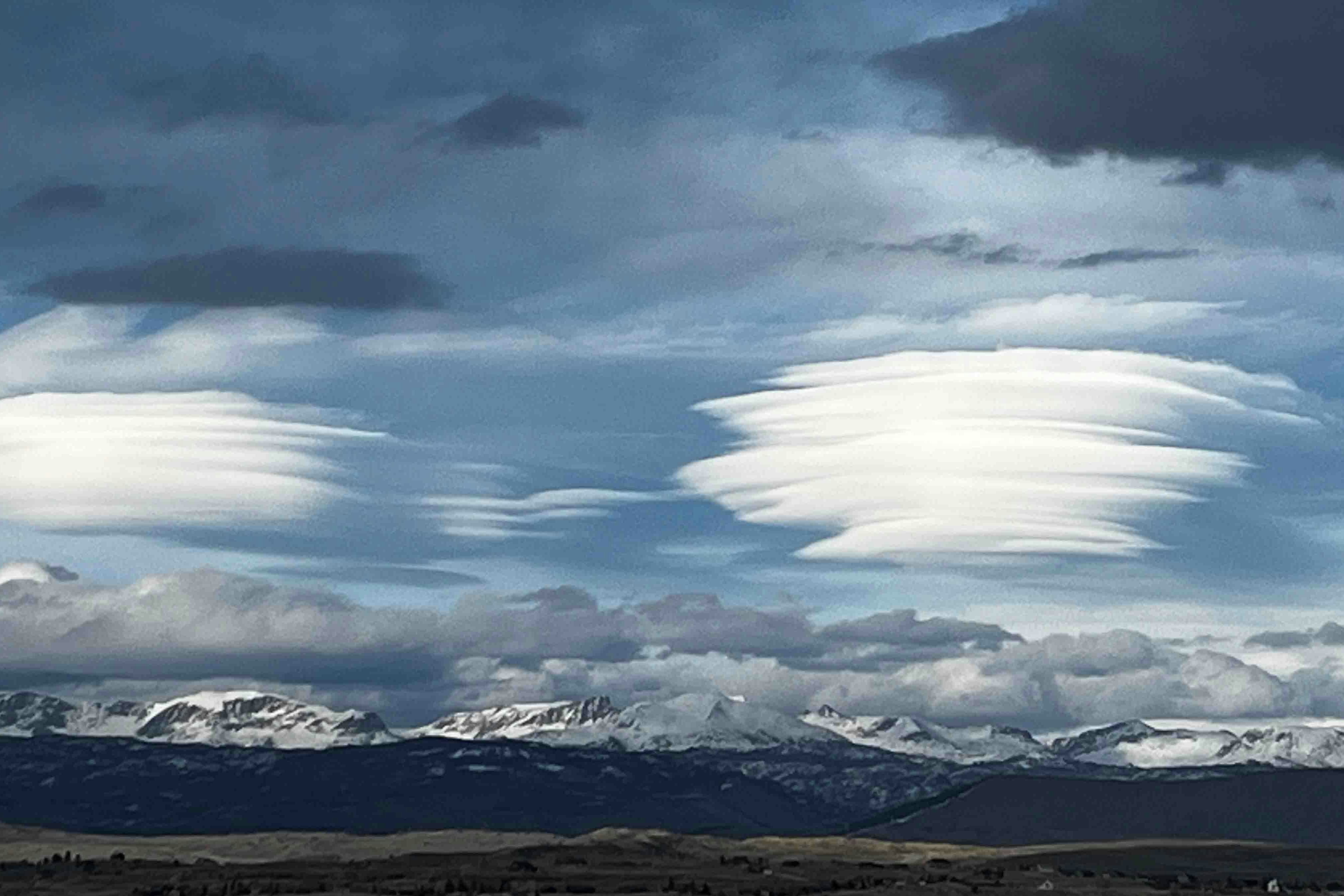 "Lenticular clouds that quickly formed then dissipated just as fast over Wind River mountains just after 7 PM on Tuesday, 4/16/24"