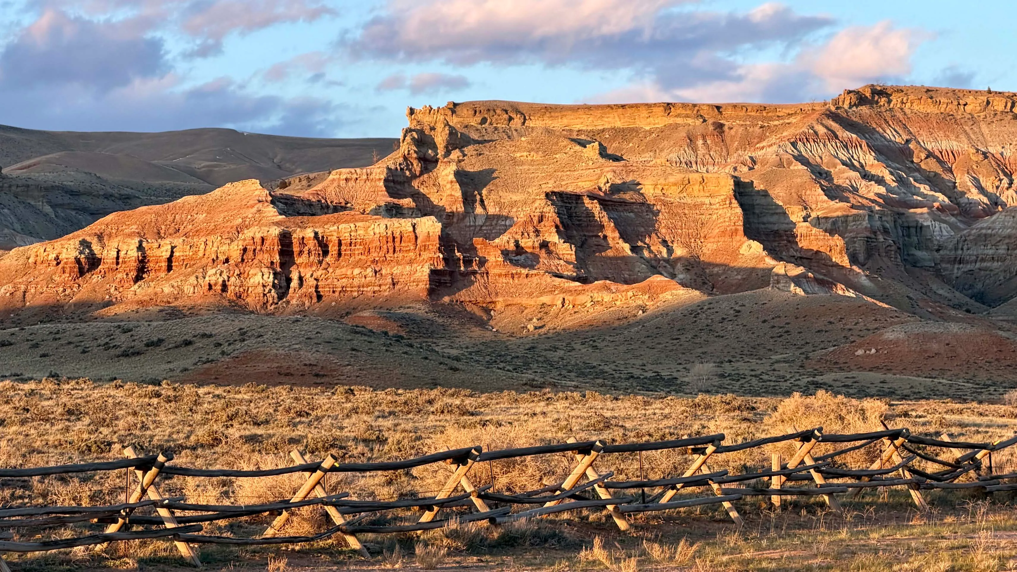 "Evening sunset casting shadows across the Dubois Badlands."