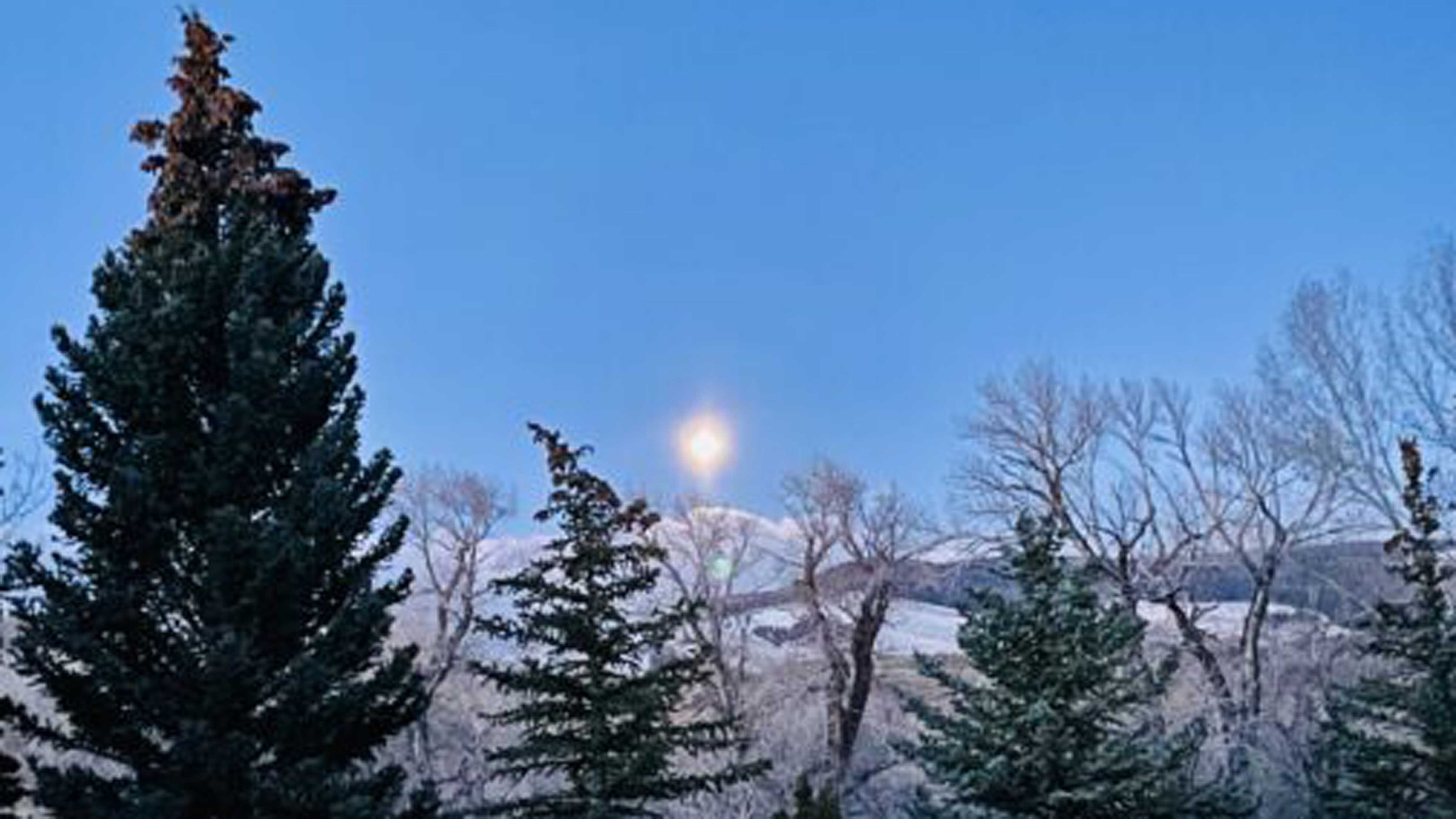"The moon just before daybreak, between Noon Rocks and Windy Mountain. 'Gave the luster of midday to objects below.'"