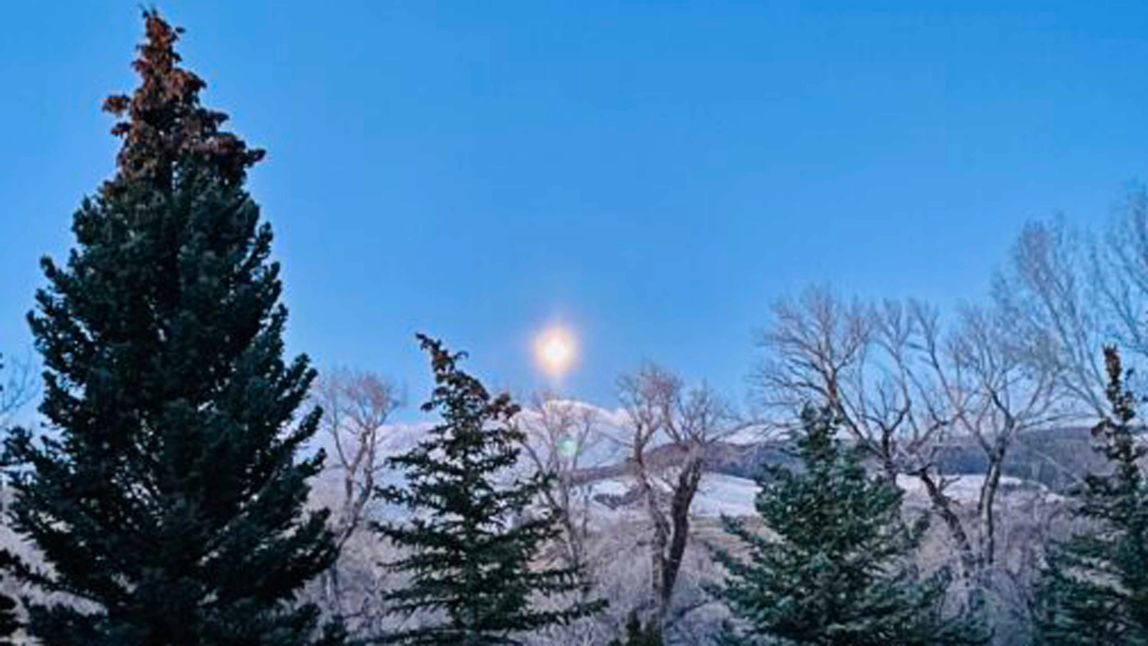 "The moon just before daybreak, between Noon Rocks and Windy Mountain. 'Gave the luster of midday to objects below.'"