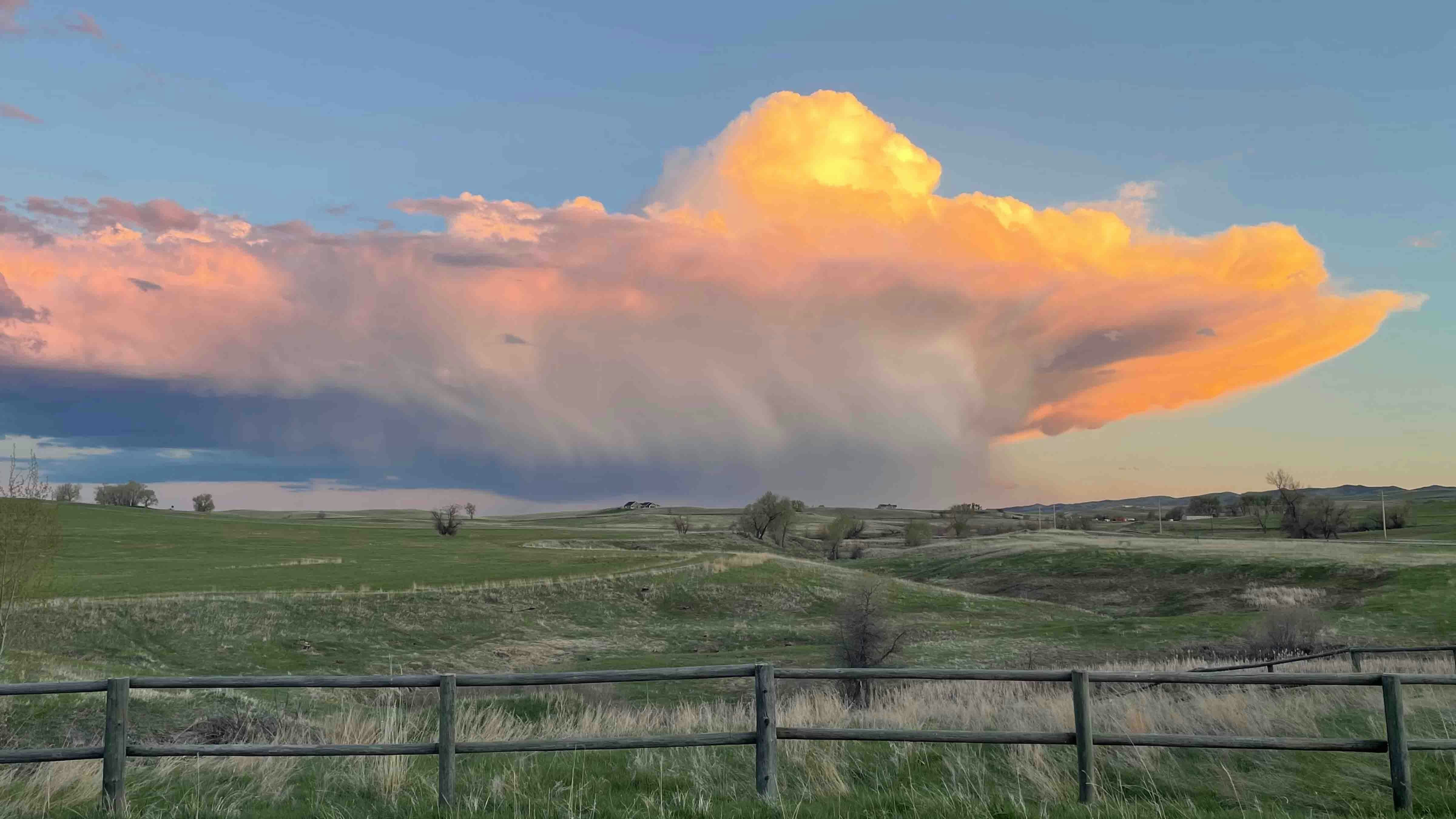 Sunset behind a rain storm along the Bighorn Mountains and Crazy Woman Canyon just South of Buffalo on May 12, 2024.