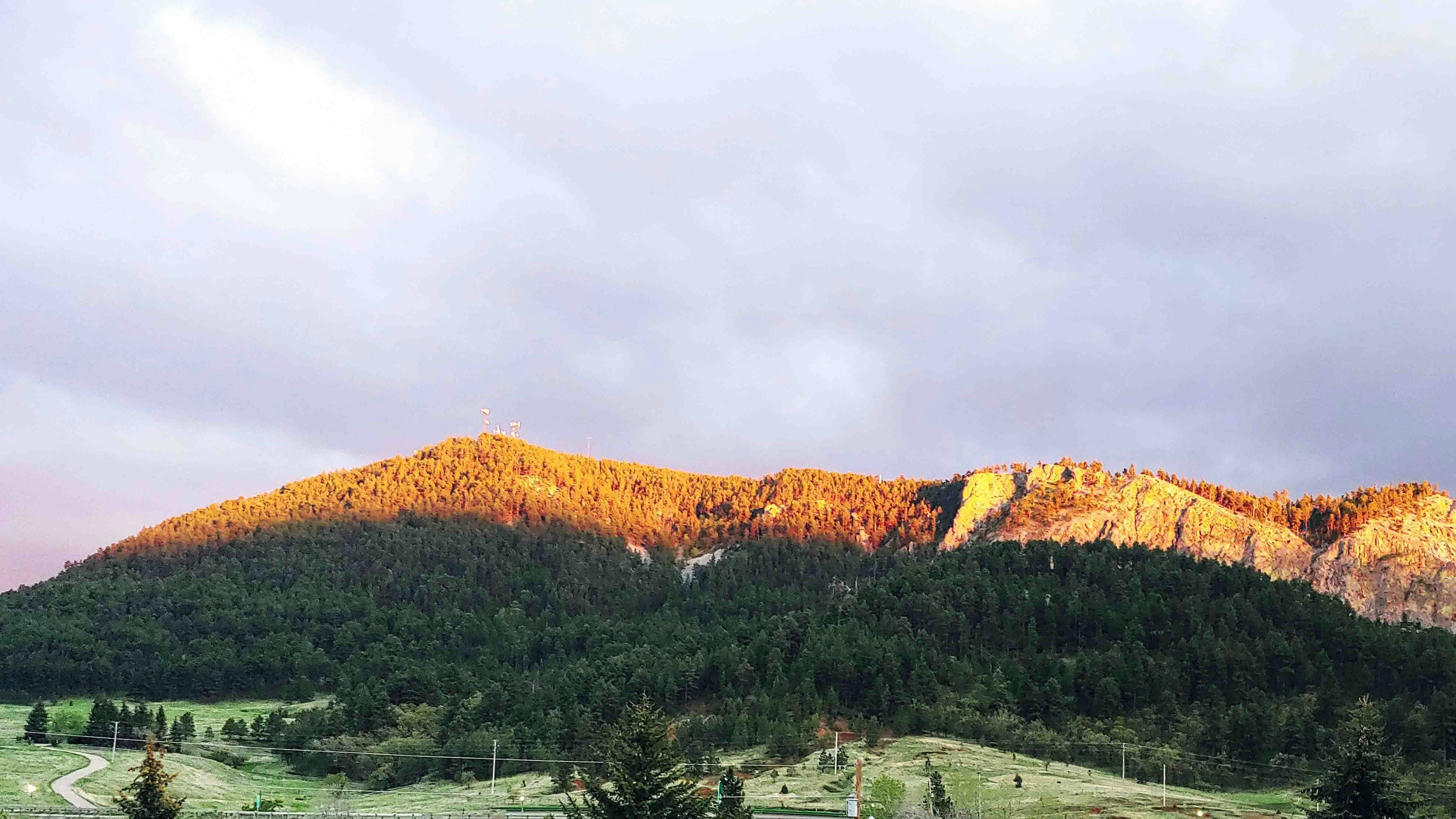 "Sundance Mountain catching the last of the sun's rays!  Rain clouds to the south. May 30, 2024"