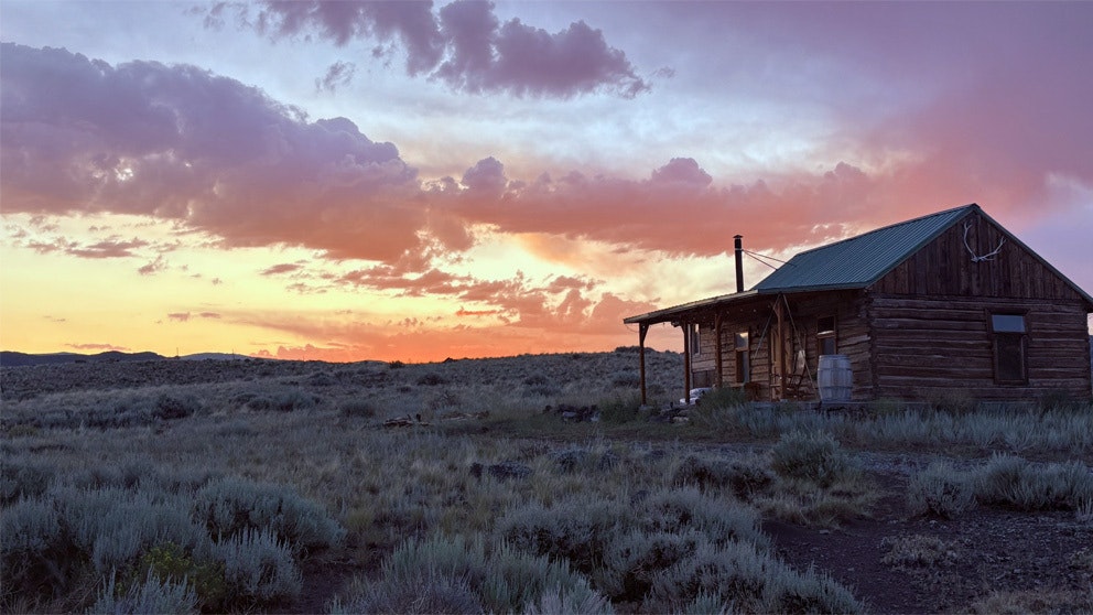 Late night storms breakup leaving beautiful cloud formations and prismatic light over Wapiti WY.