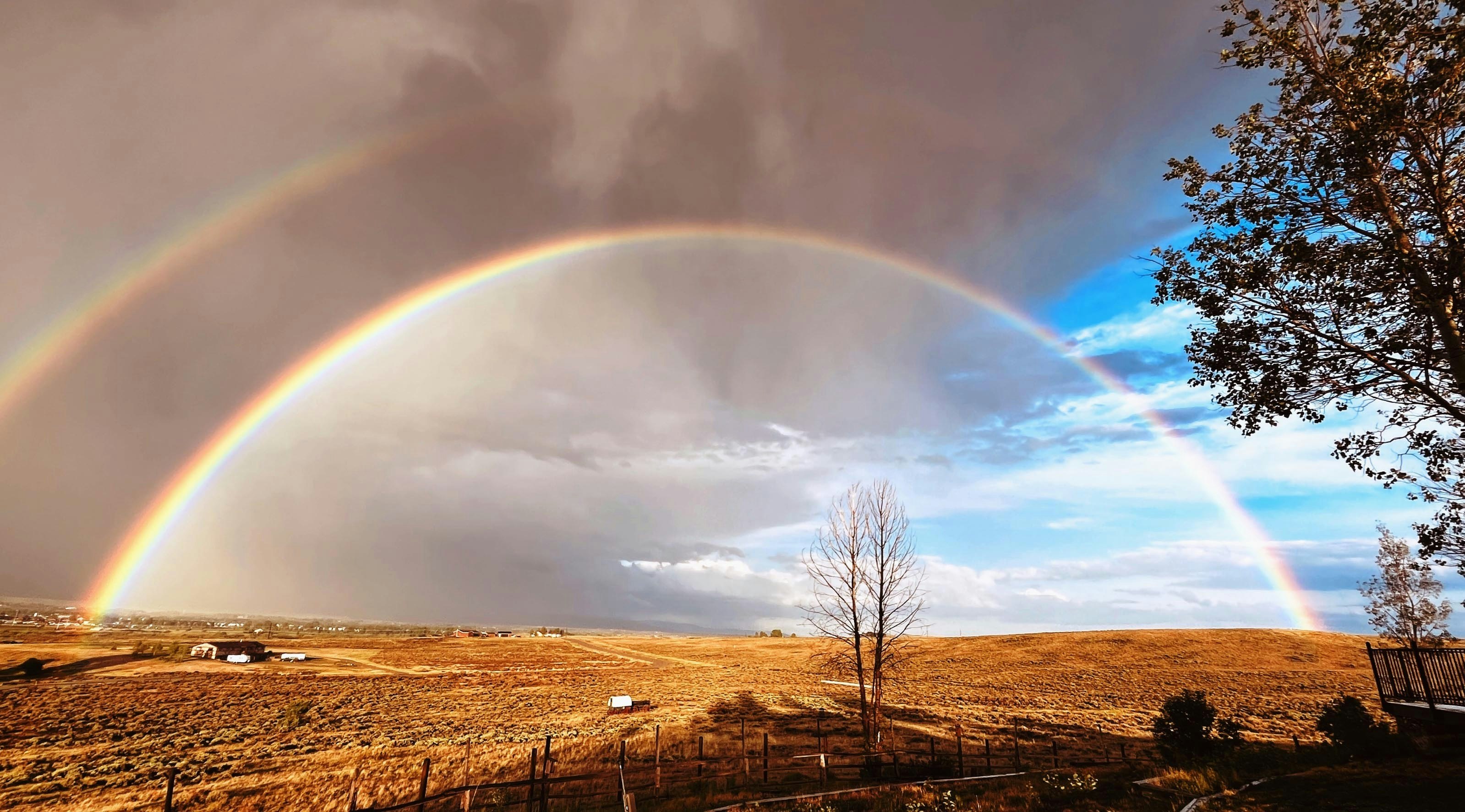 "Post thunderstorm double rainbow looking east toward Pinedale on June 26, 2024."