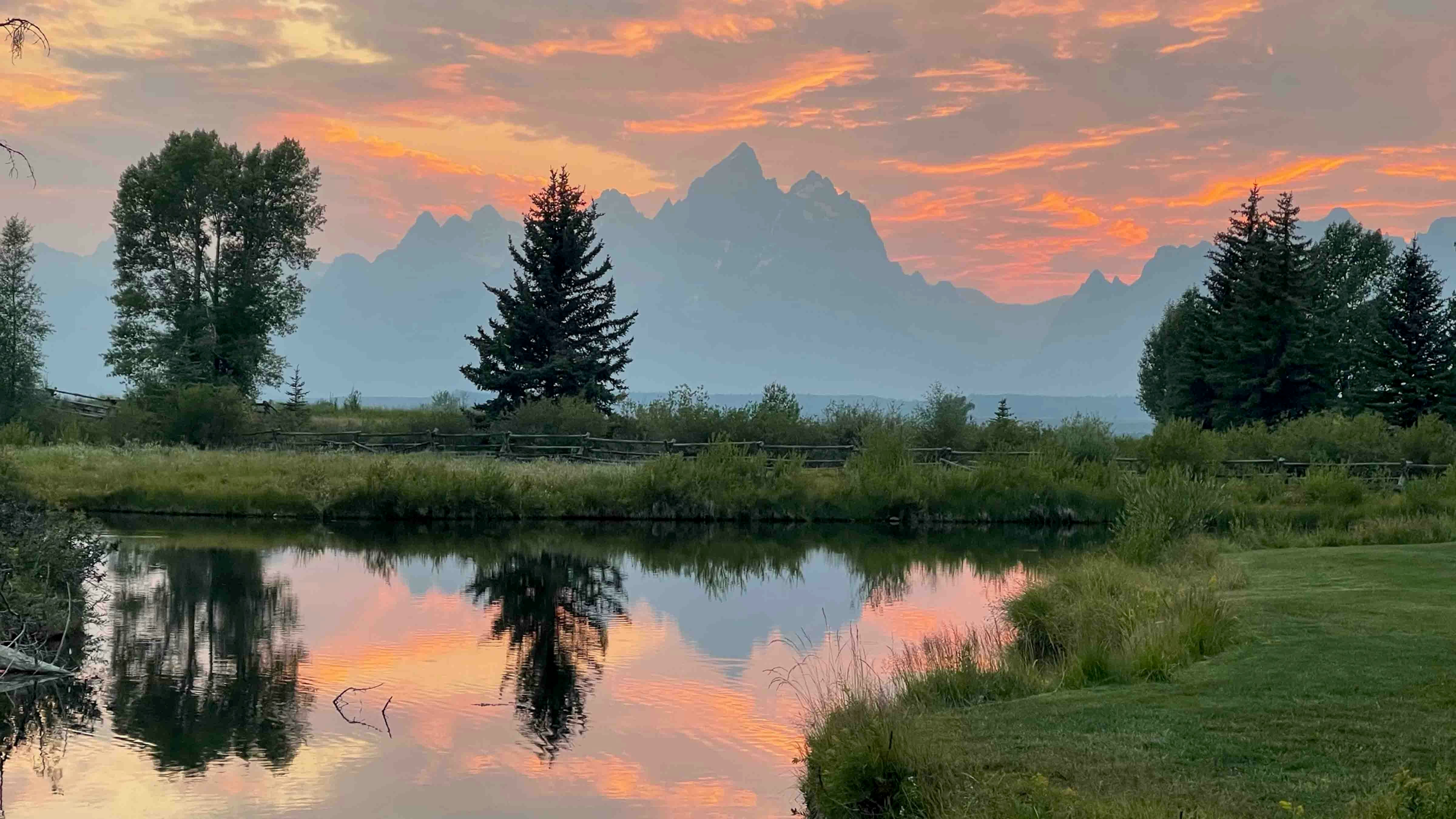 "Lots of haze and smoke despite which the Tetons are majestic. Taken from Moosehead Ranch on August 8, 2024."