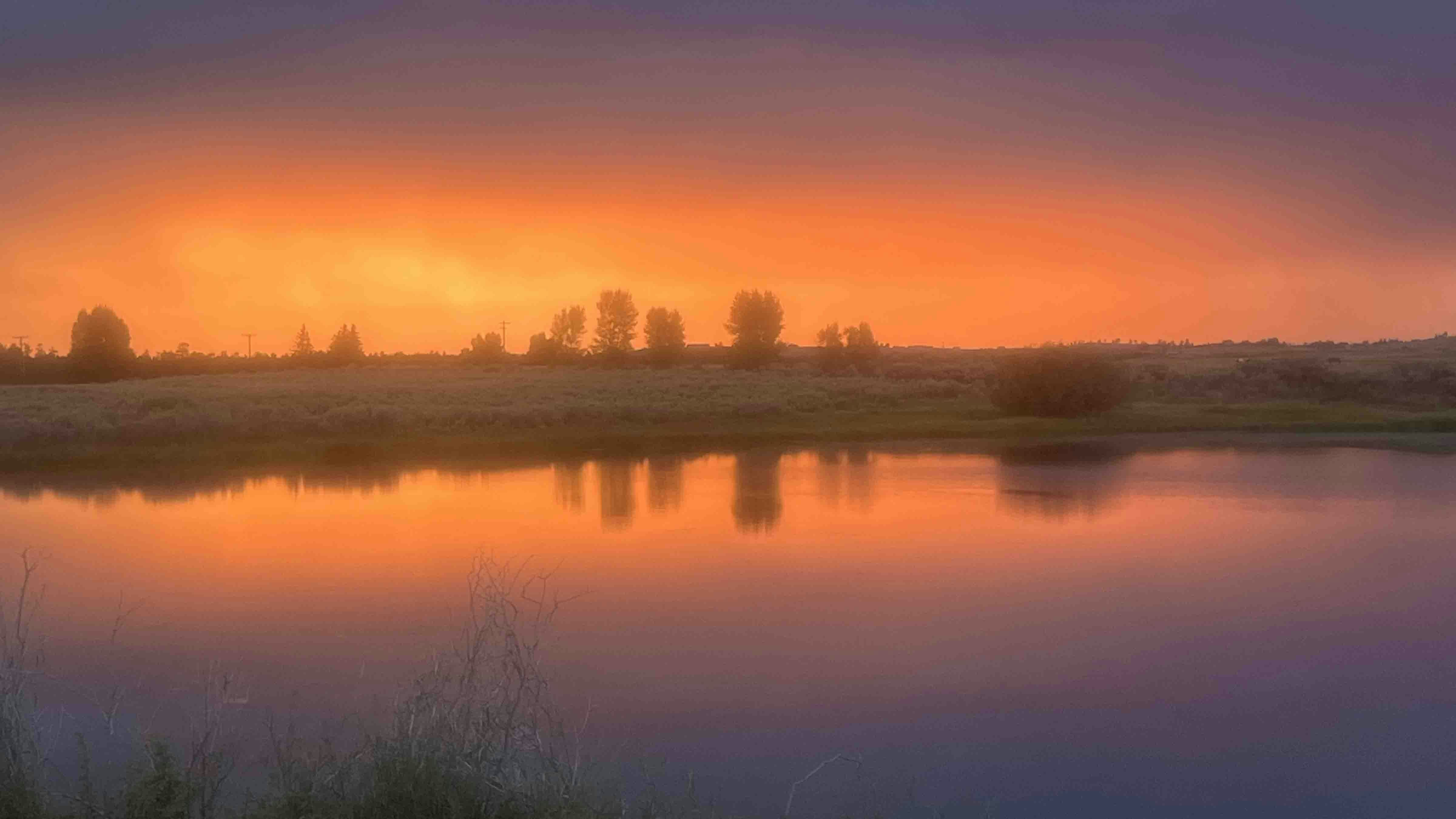 "We’ve had some beautiful sunsets lately. Loved the reflection of this one in our pond! Taken in Pinedale."