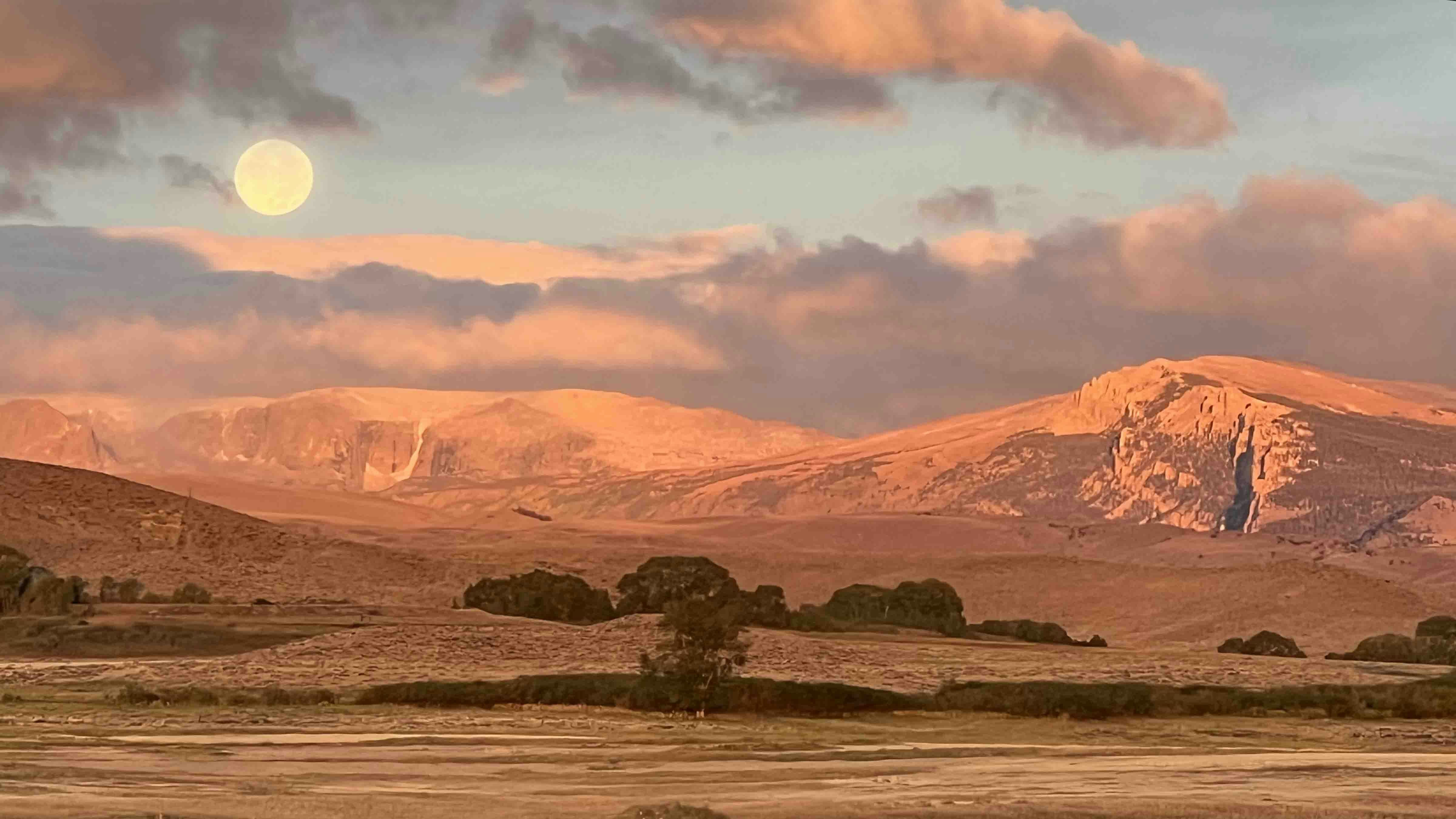 "Driving from Lander to Jackson this morning. Watching the sunrise and the moonset."